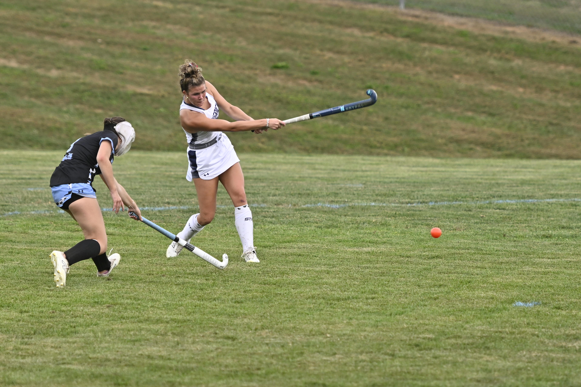 Manchester Valley's Taylor Fique strikes the ball hard as she...