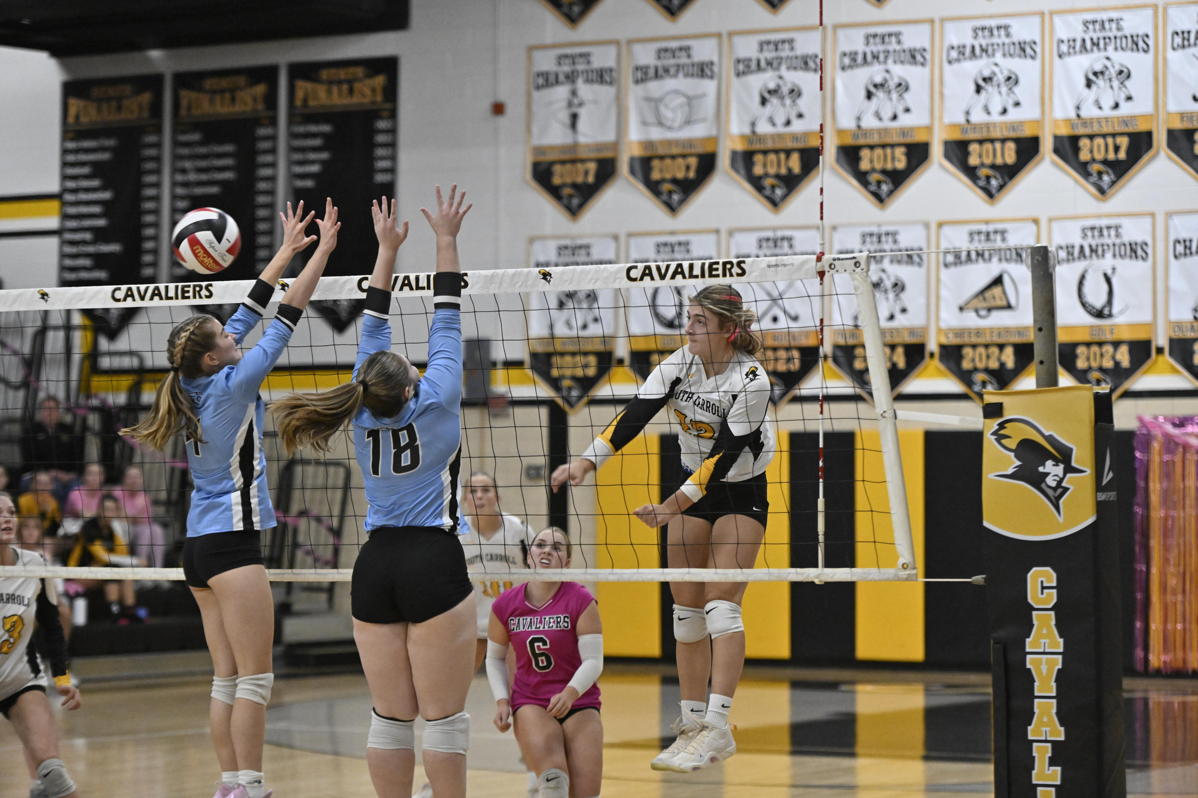 Elaina Murphy spikes the ball past Westminster's Jaiden Hammel, left,...