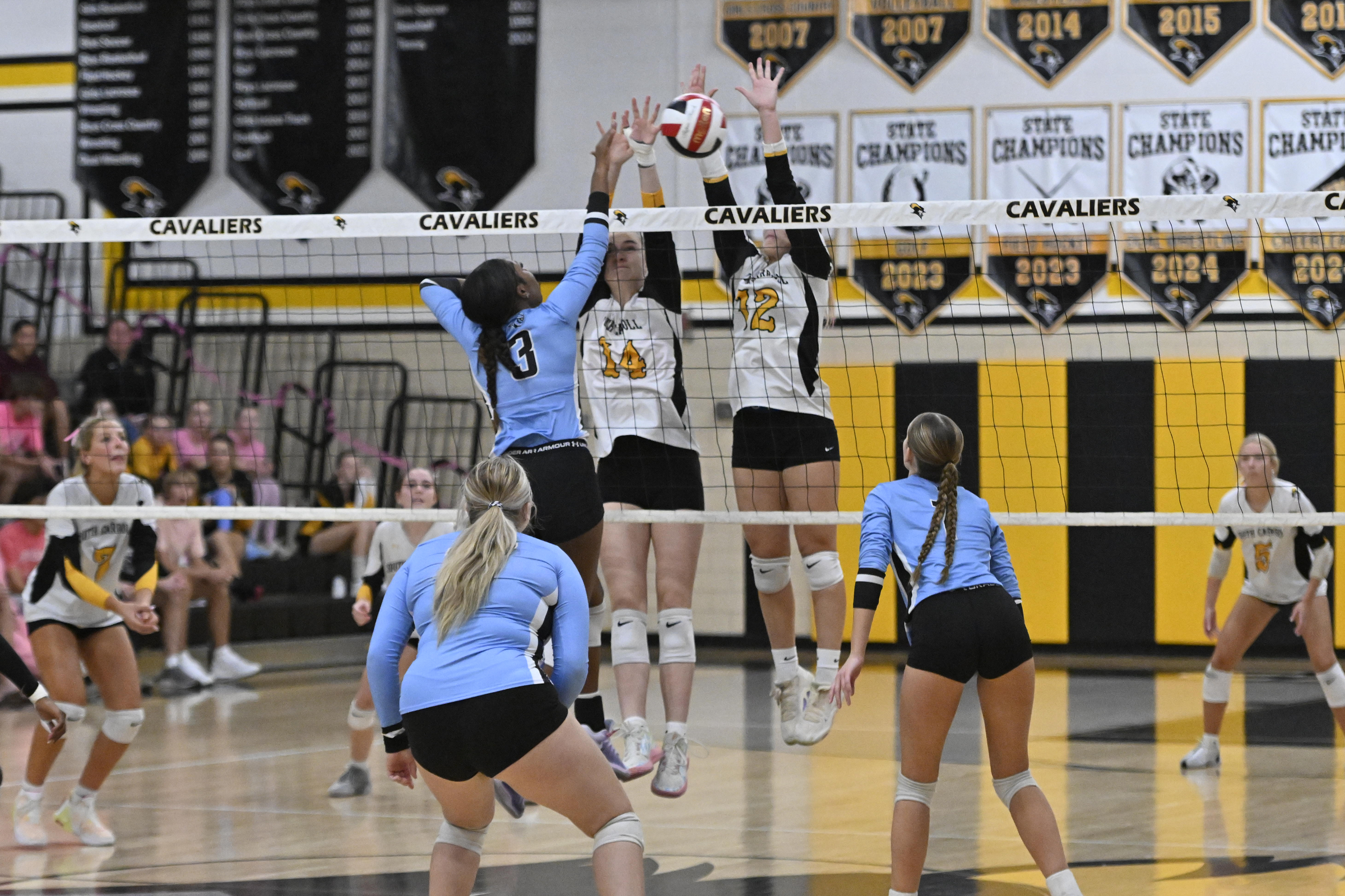 Westminster's Peyton Marrow spikes the ball as Jenna Todd, left,...