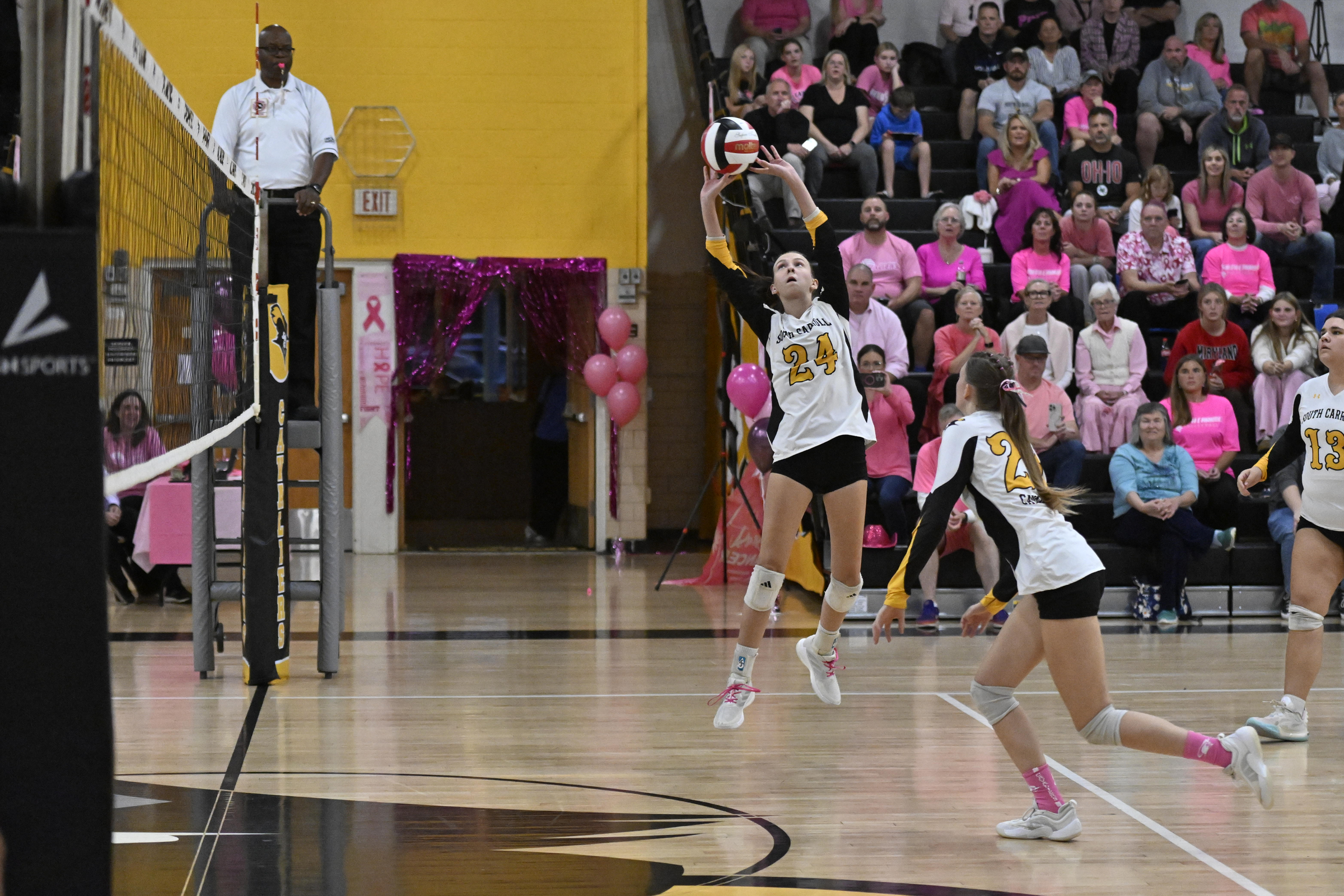 Makenzie Kutzler pushes the ball over the net during a...