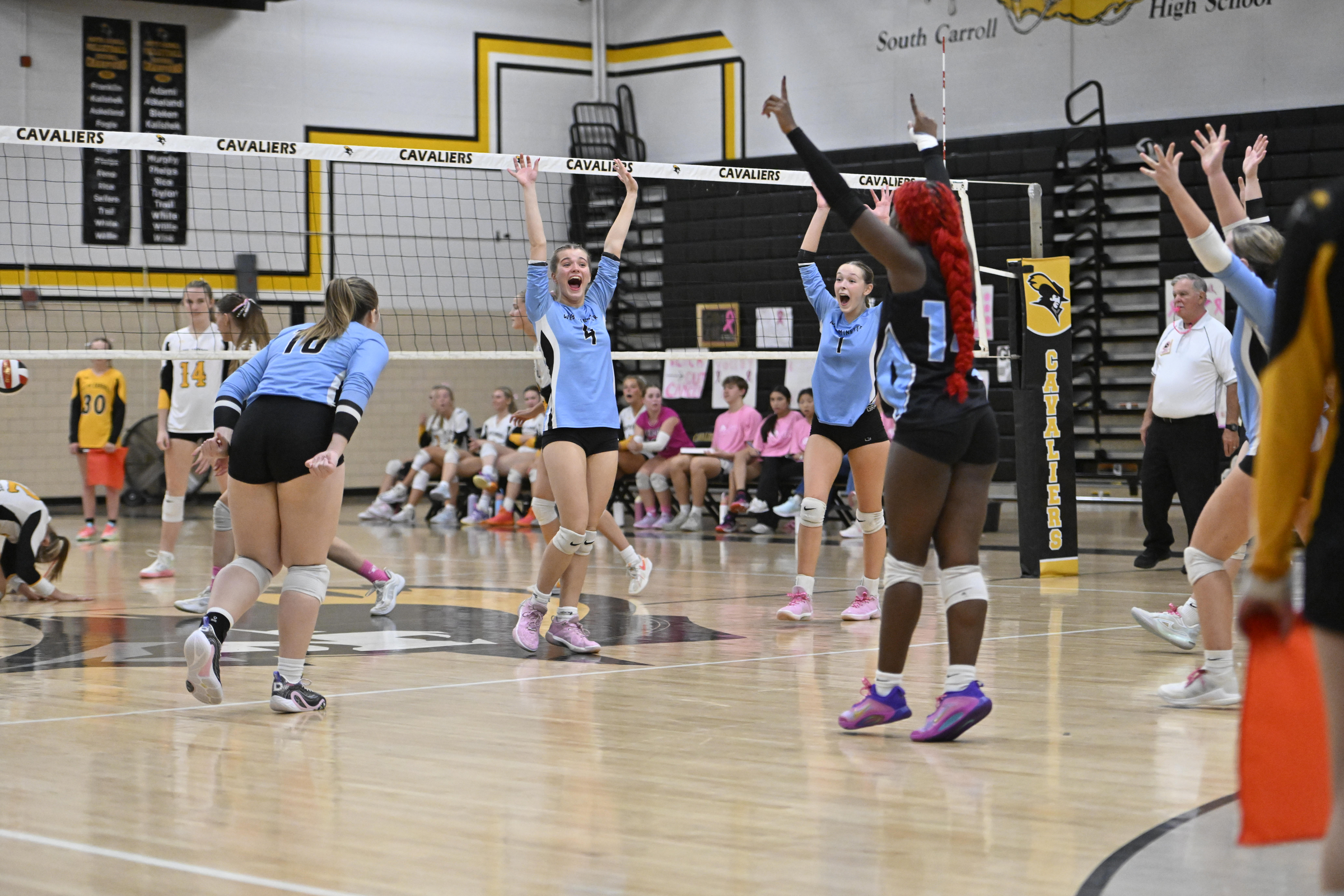 Westmisnter's Jaiden Hammel and her teammates celebrates scoring a point...