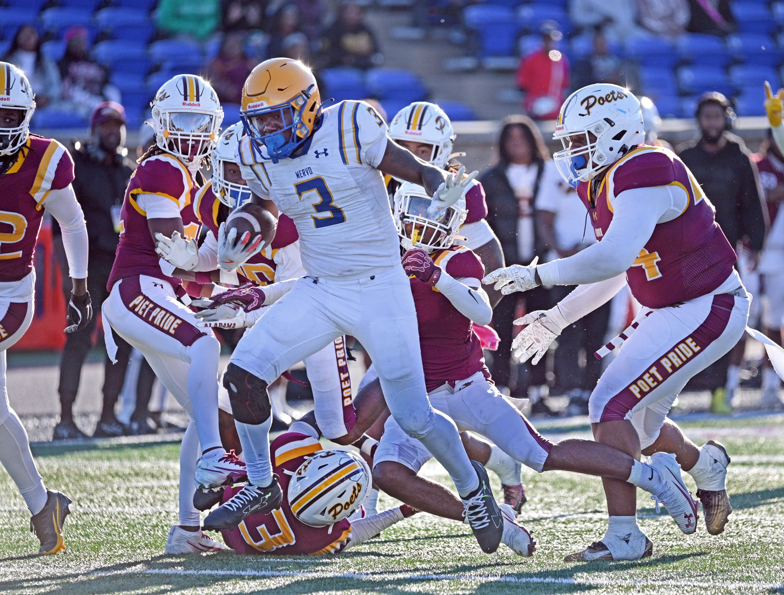 Mervo’s Kaden Foster, center, breaks away from Dunbar defenders to...