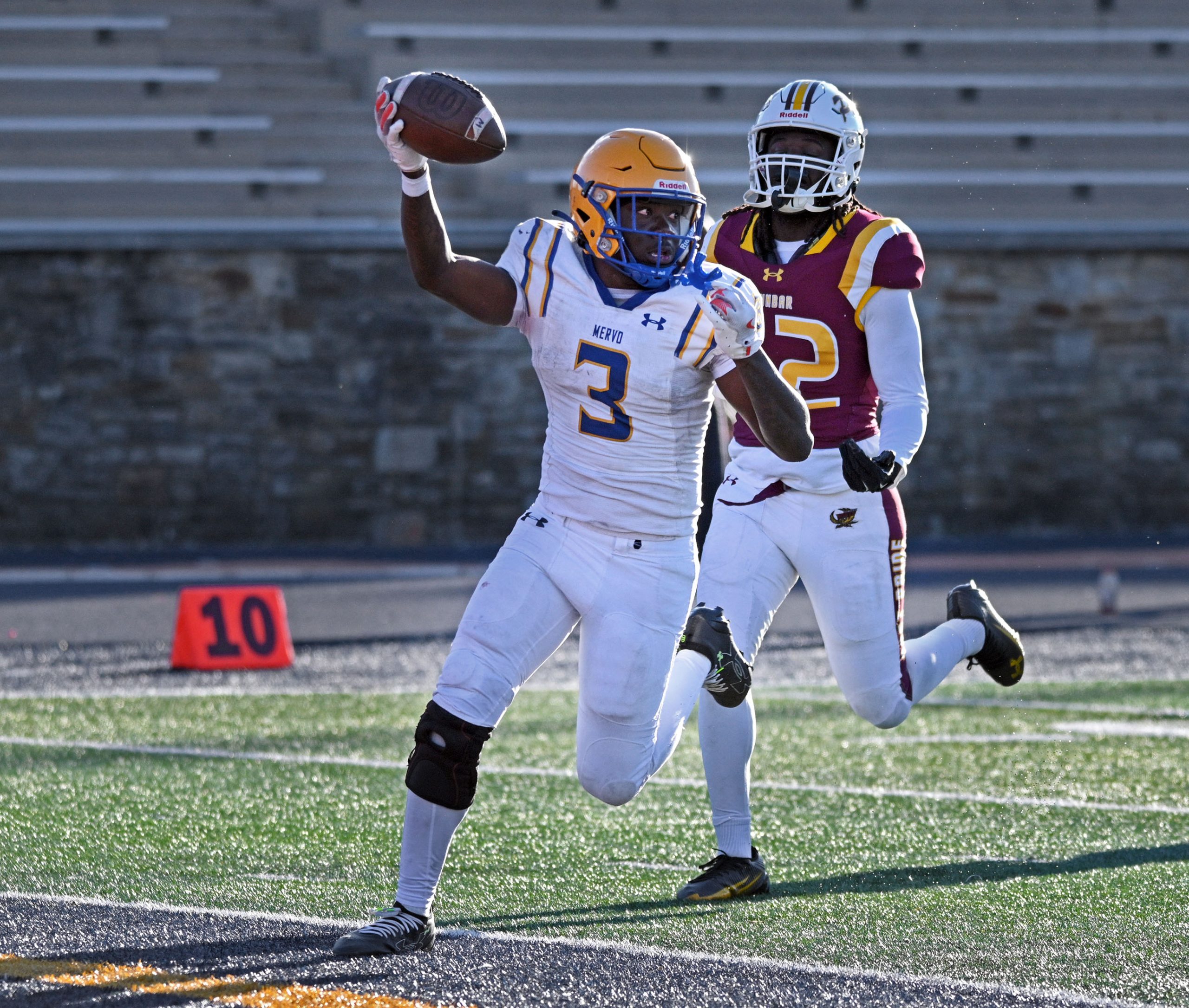 Mervo’s Kaden Foster, left, runs away from Dunbar’s Amir Hicks,...