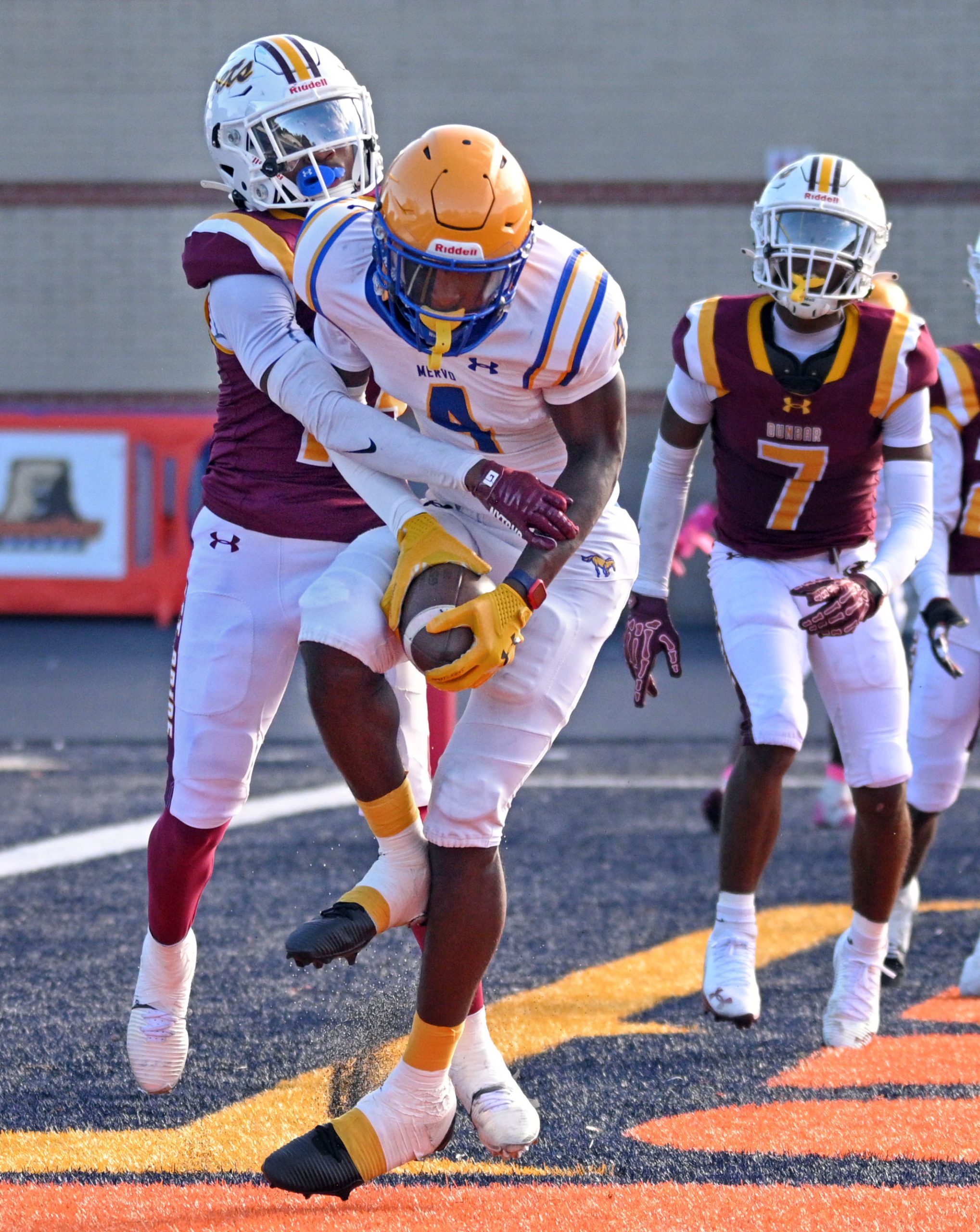 Mervo’s Brandon Jefferson, center, scores a two-point conversion against Dunbar’s...