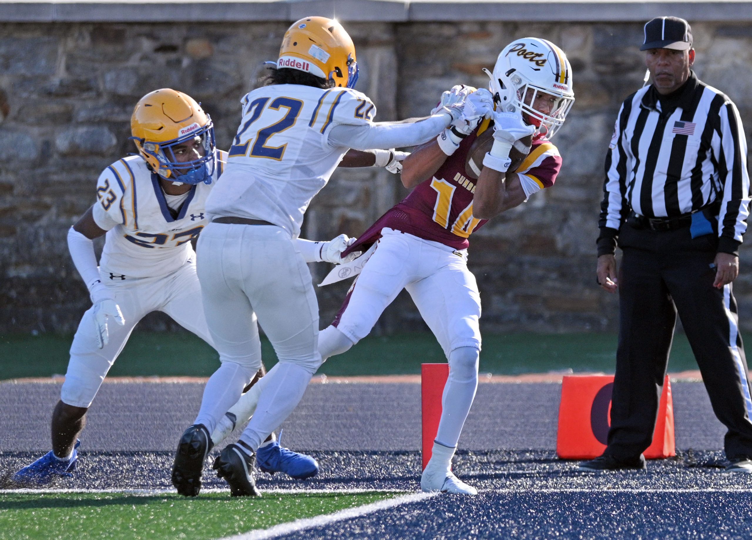 Dunbar’s Khamari Tucker, right, scores a touchdown against Mervo’s Khazhon...