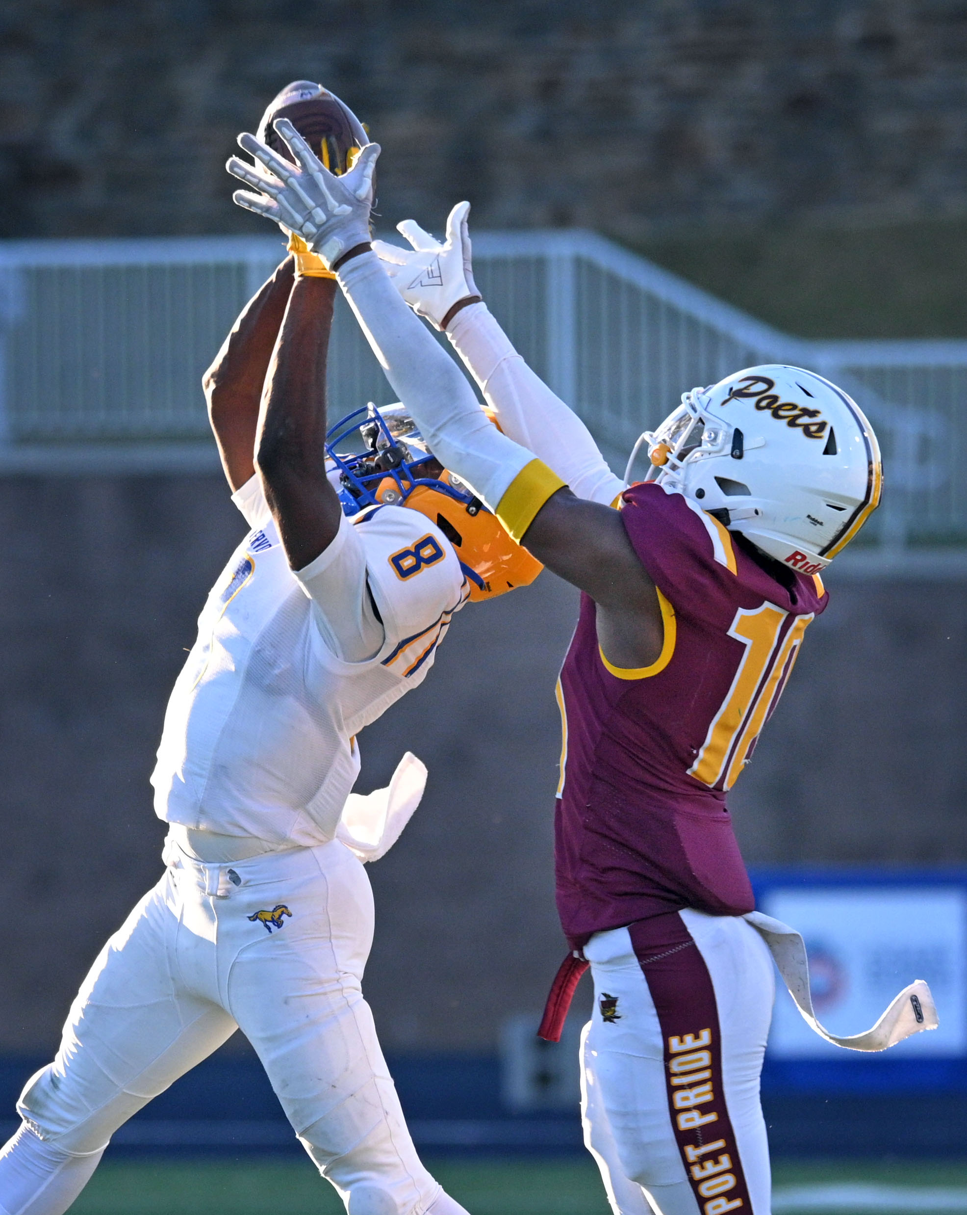 Mervo’s Cleveland Deshields, left, intercepts a pass intended for Dunbar’s...