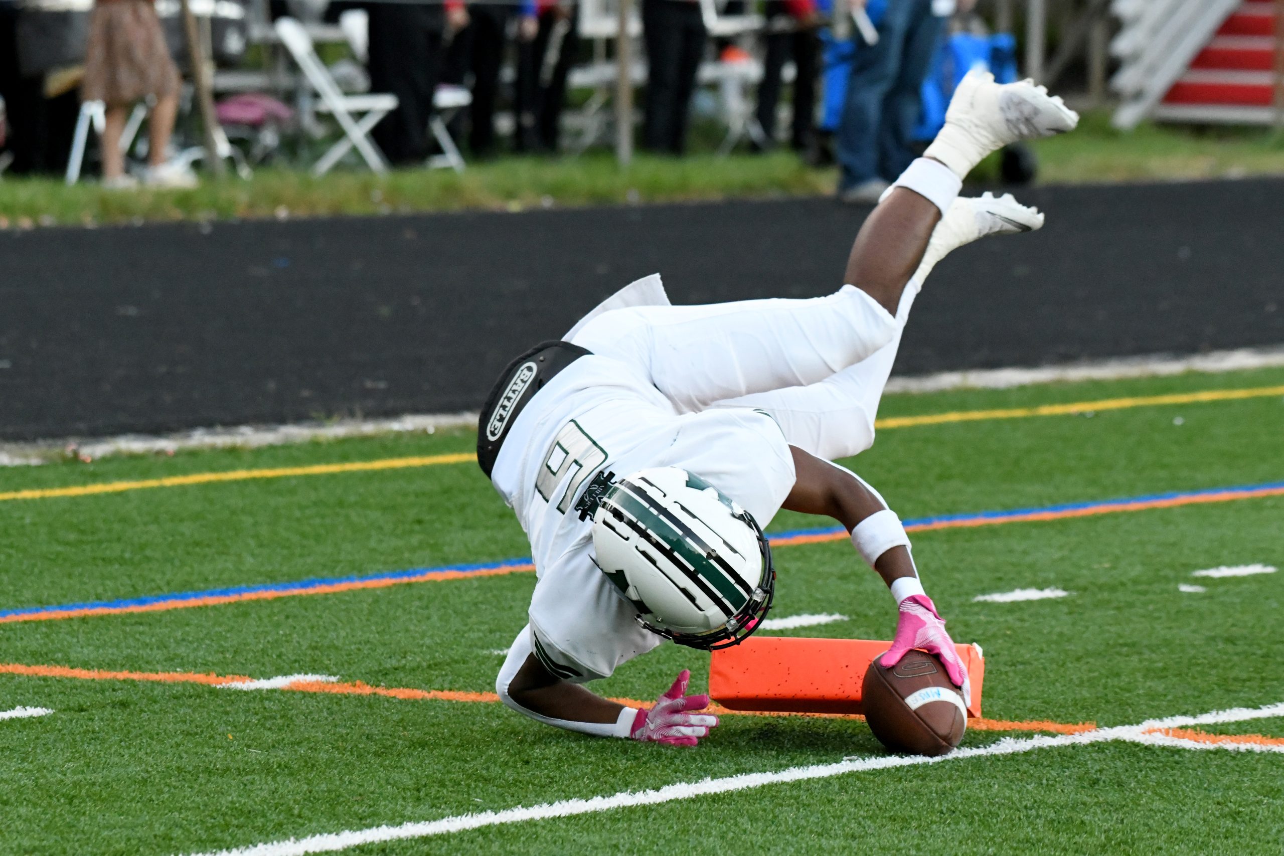 Dejuan Nelson, Milford Mill, tumbles into the end zone to...