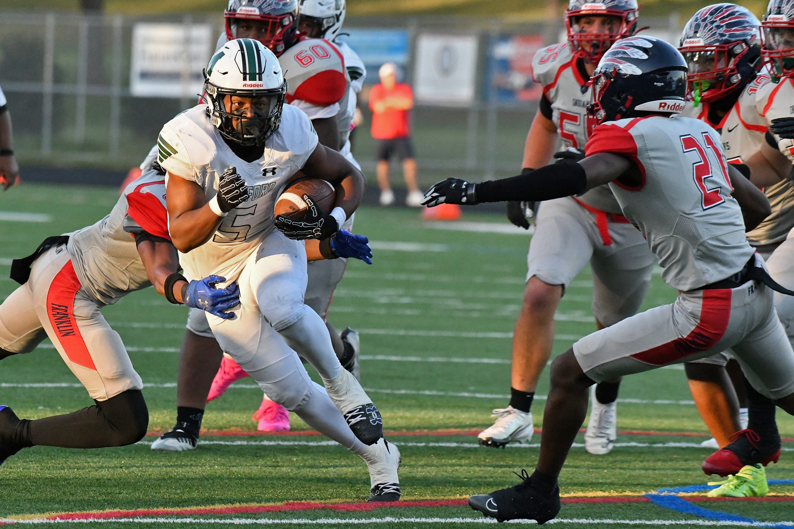 Damon Ferguson, Milford Mill, runs the ball as Chideziri Duru,...