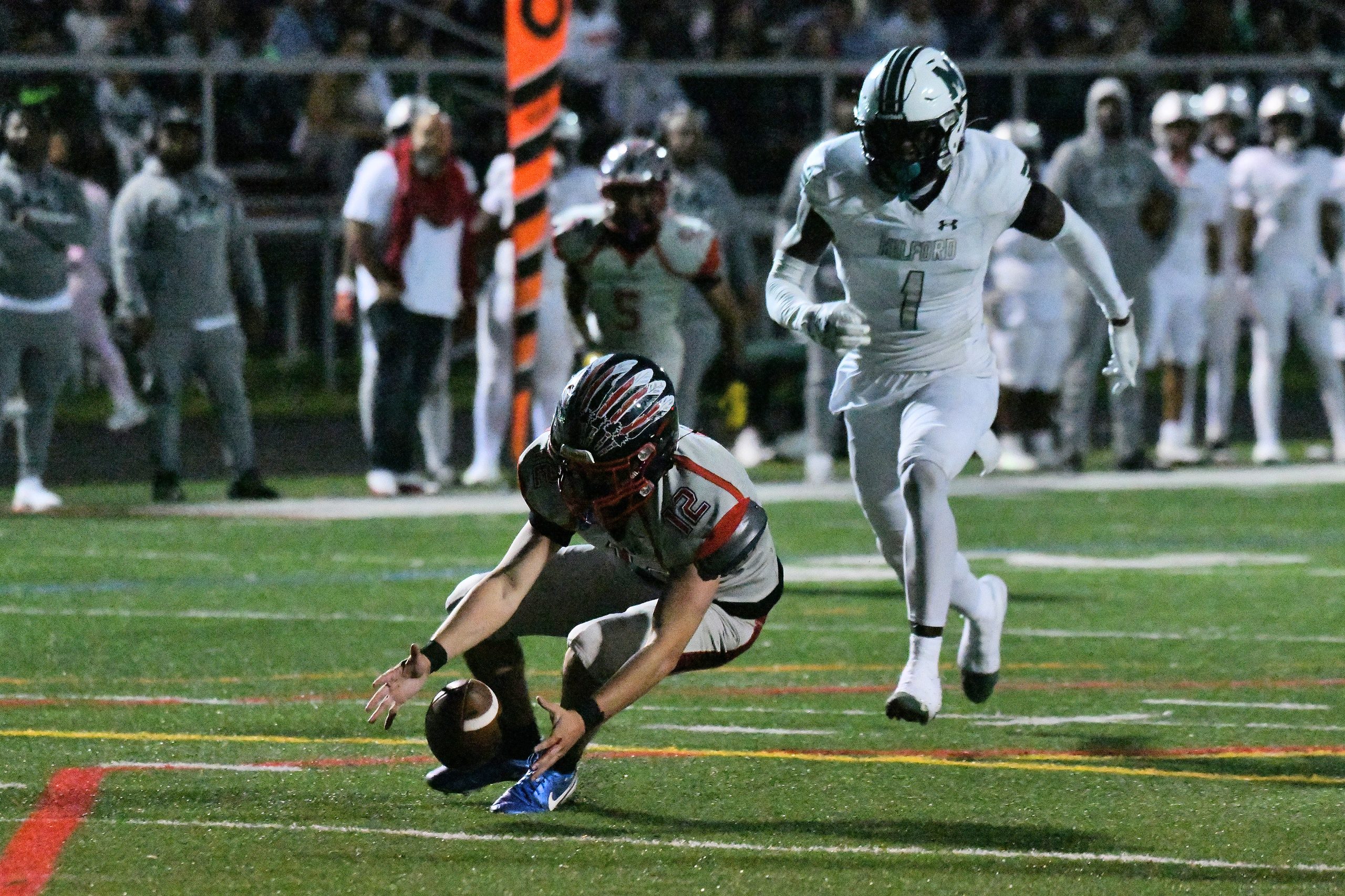Franklin quarterback Tanner Hutchins tries to regain possession of a...