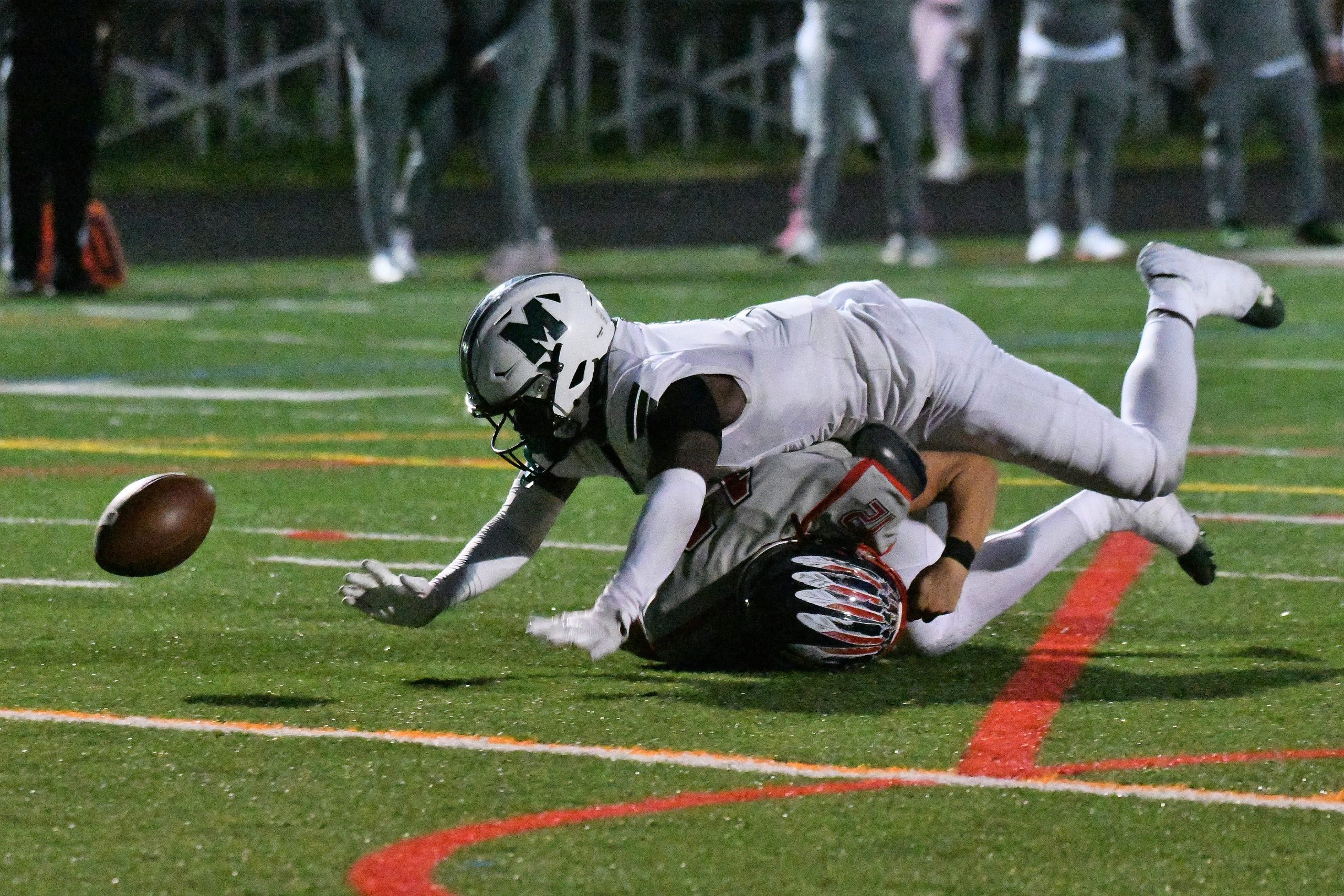 Koby Sarkodie, Milford Mill, dives over Franklin quarterback Tanner Hutchins...