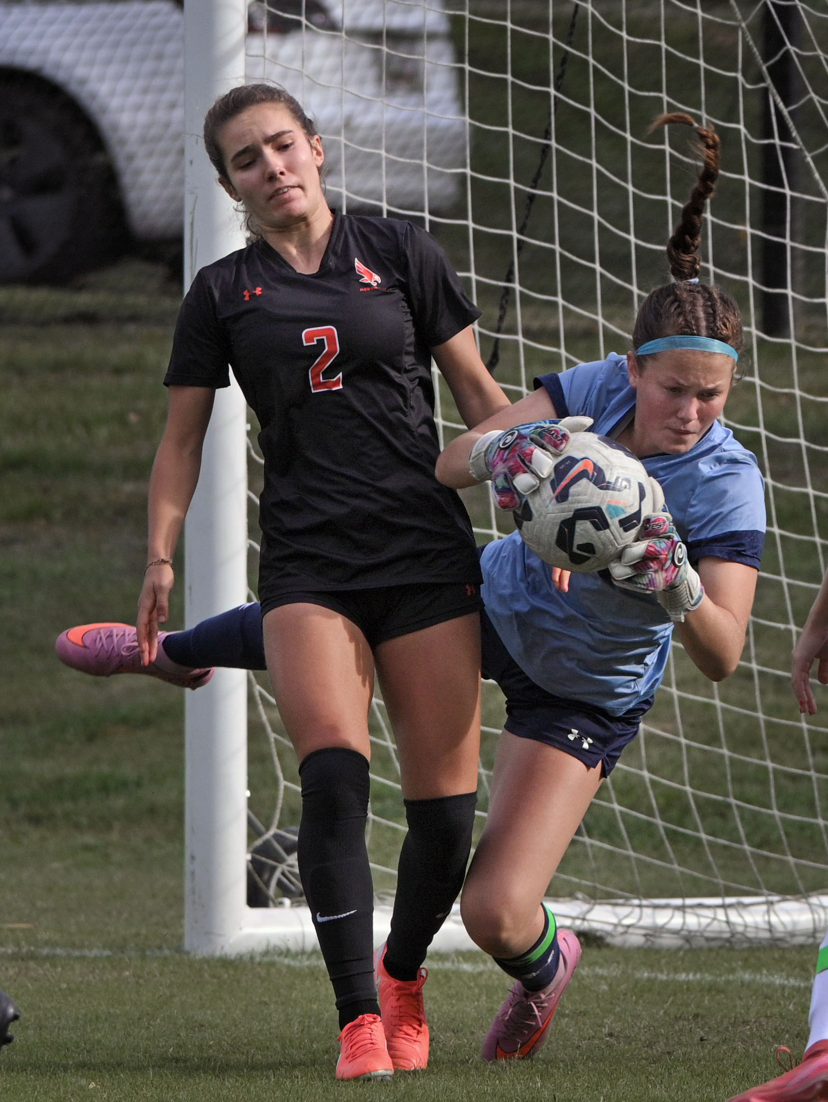 NDP goalie Lydia Itzoe, right, grabs the ball away from...