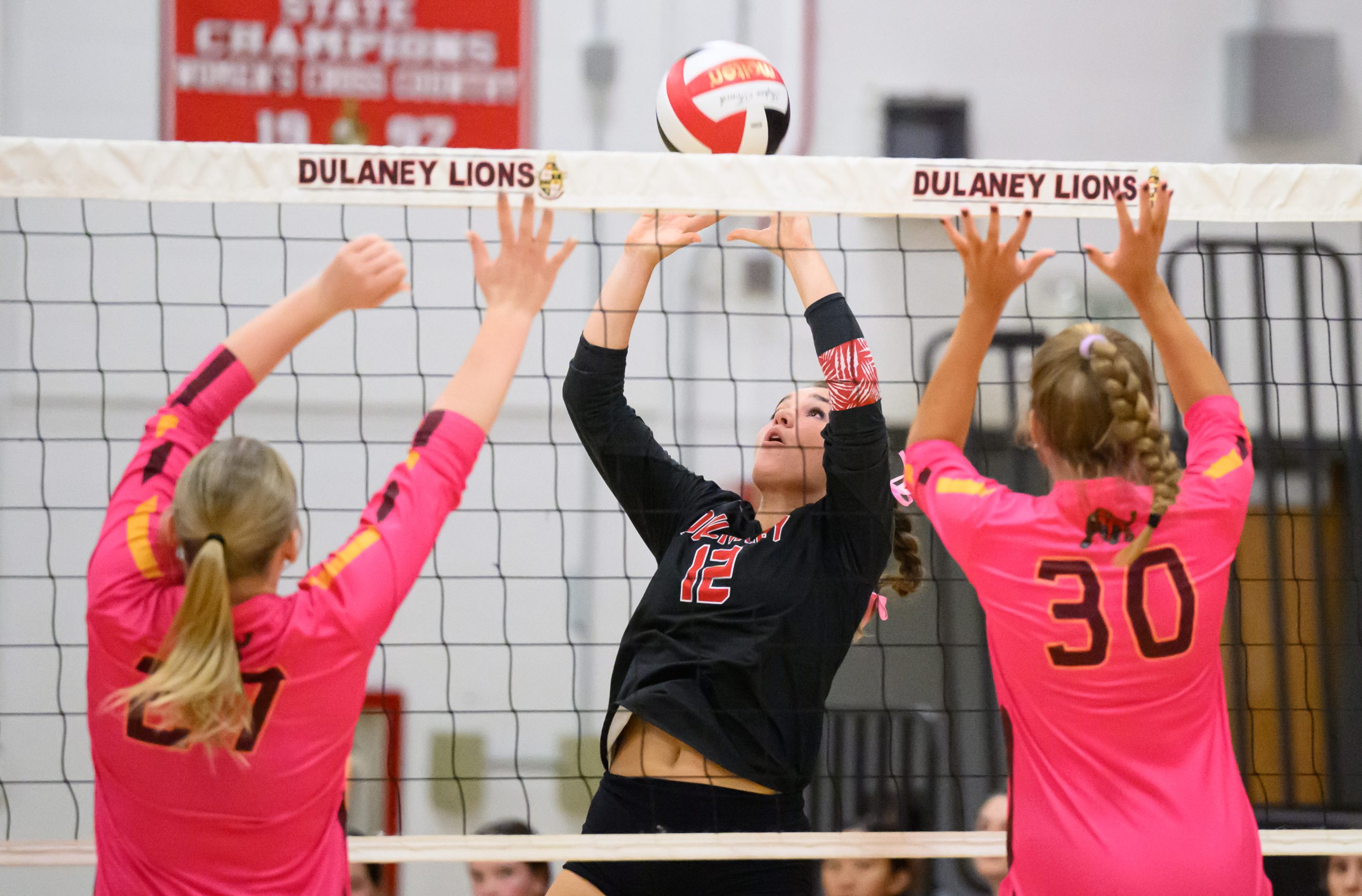 Dulaney’s Allie Leone, center, plays the net against Hereford during...