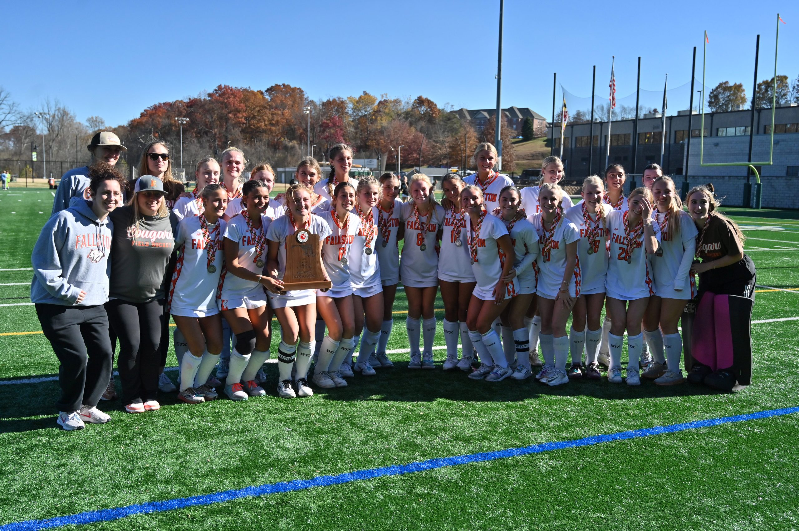 Fallston players pose with their finalist trophy following their loss...