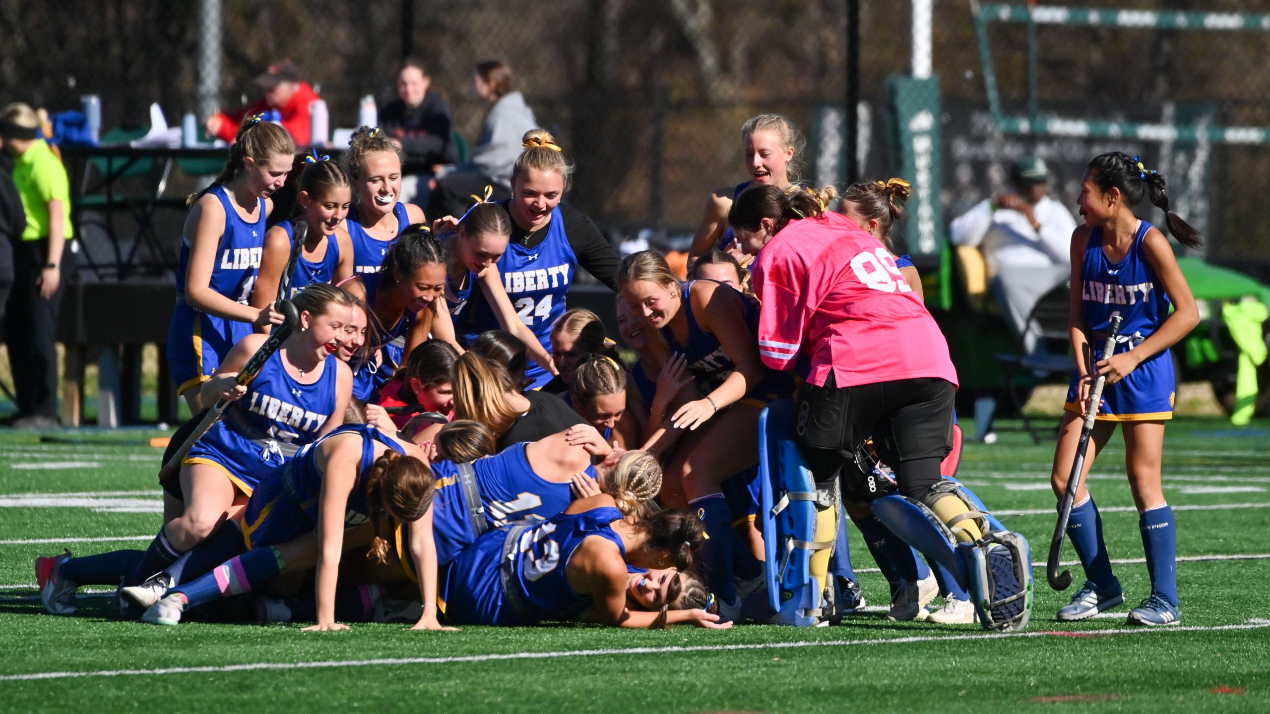 Liberty players celebrate on the field following their win over...