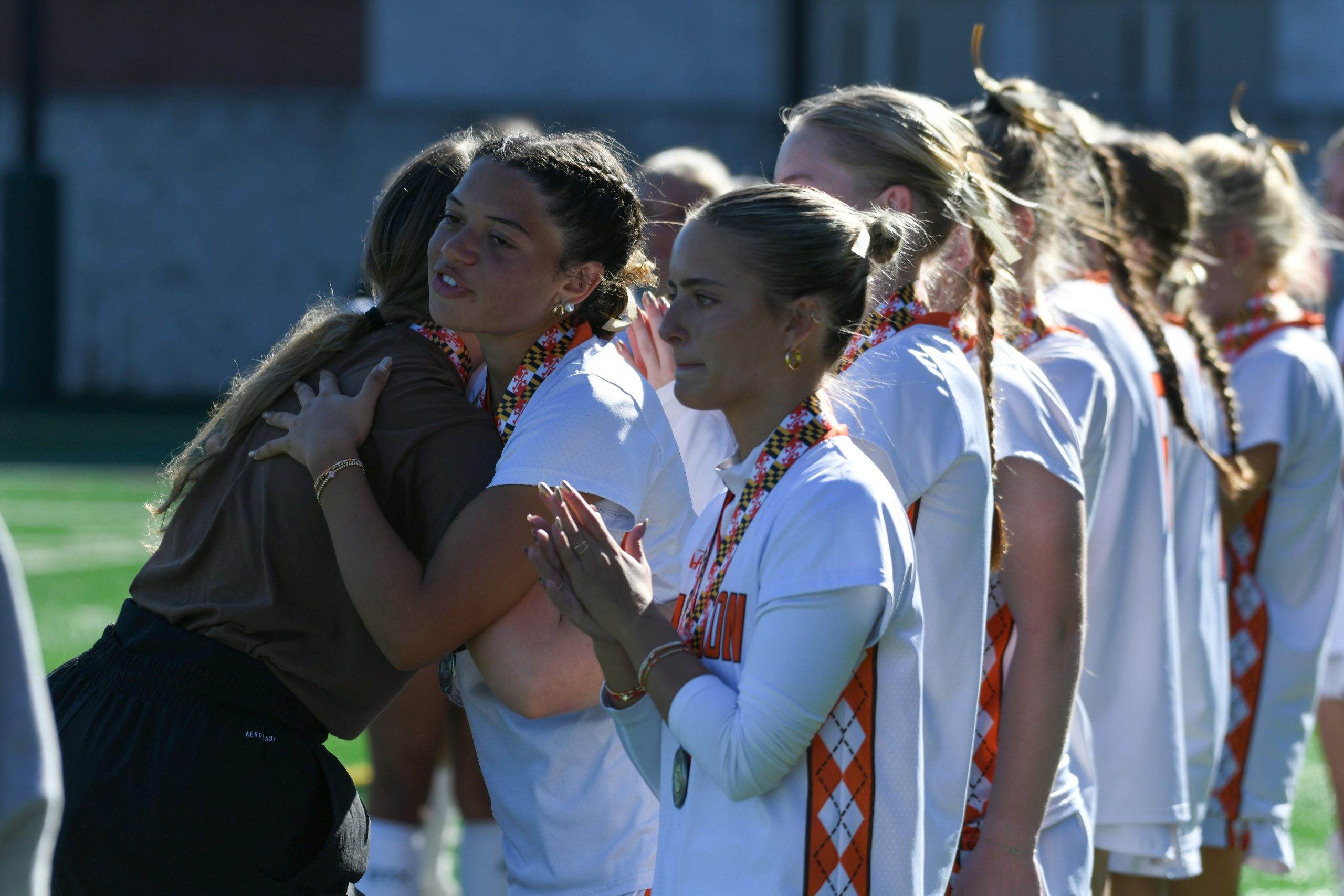 Fallston's Layla King, left, and Devyn Snyder greets their teammates...