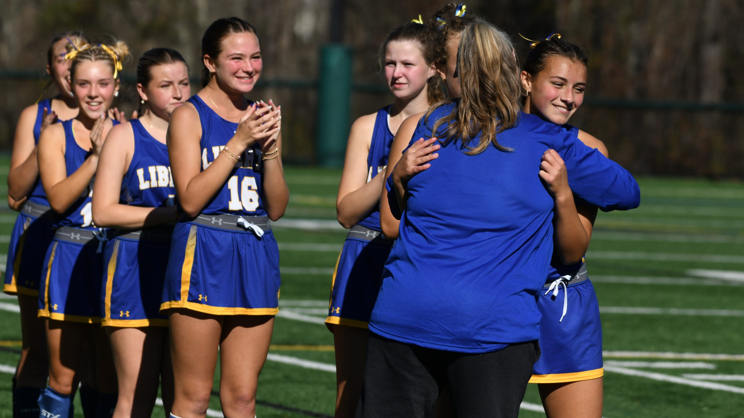 Liberty coach Brenda Strohmer embraces Clara Robbins, right, as the...