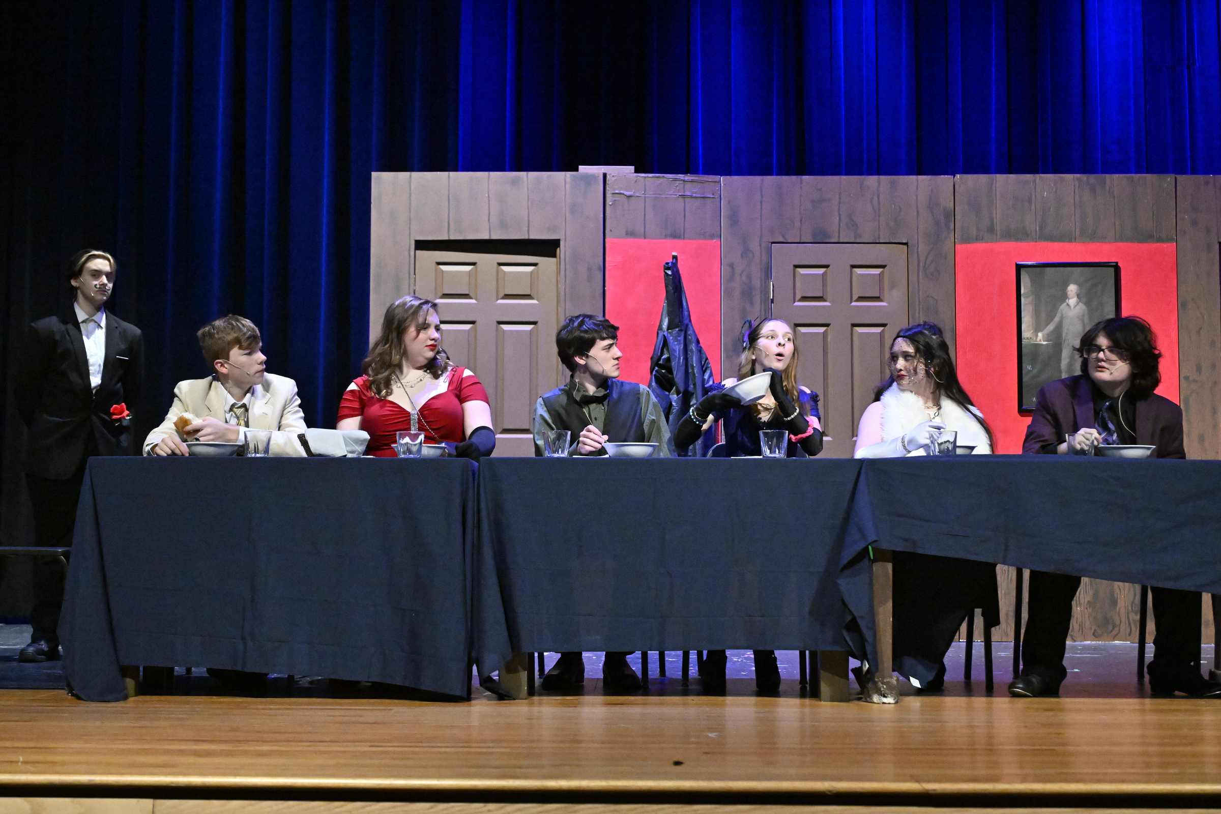 The dinner guests react to :Mrs. Peacock, played by Maggie...