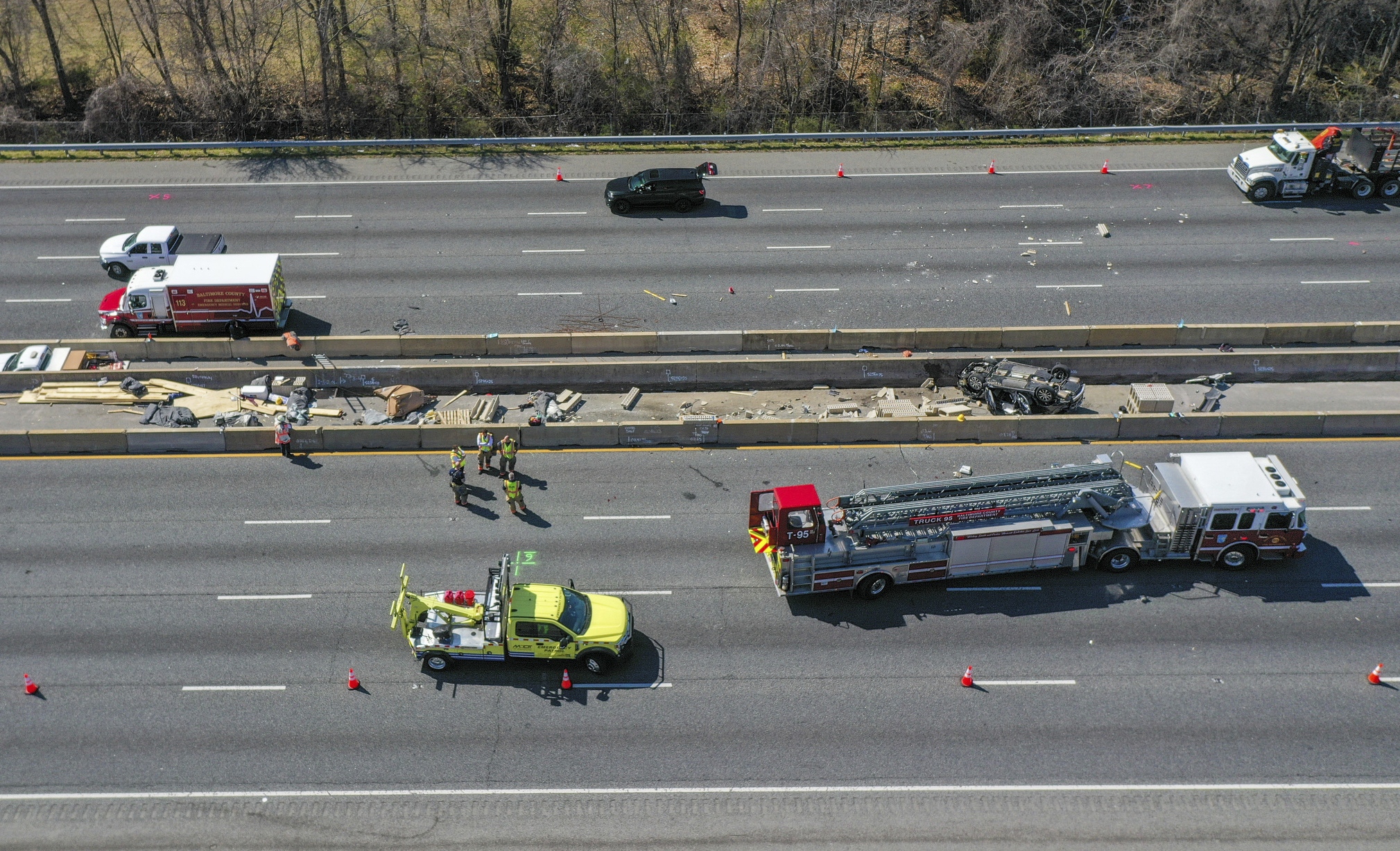 Emergency personnel work at the scene of fatal crash along...