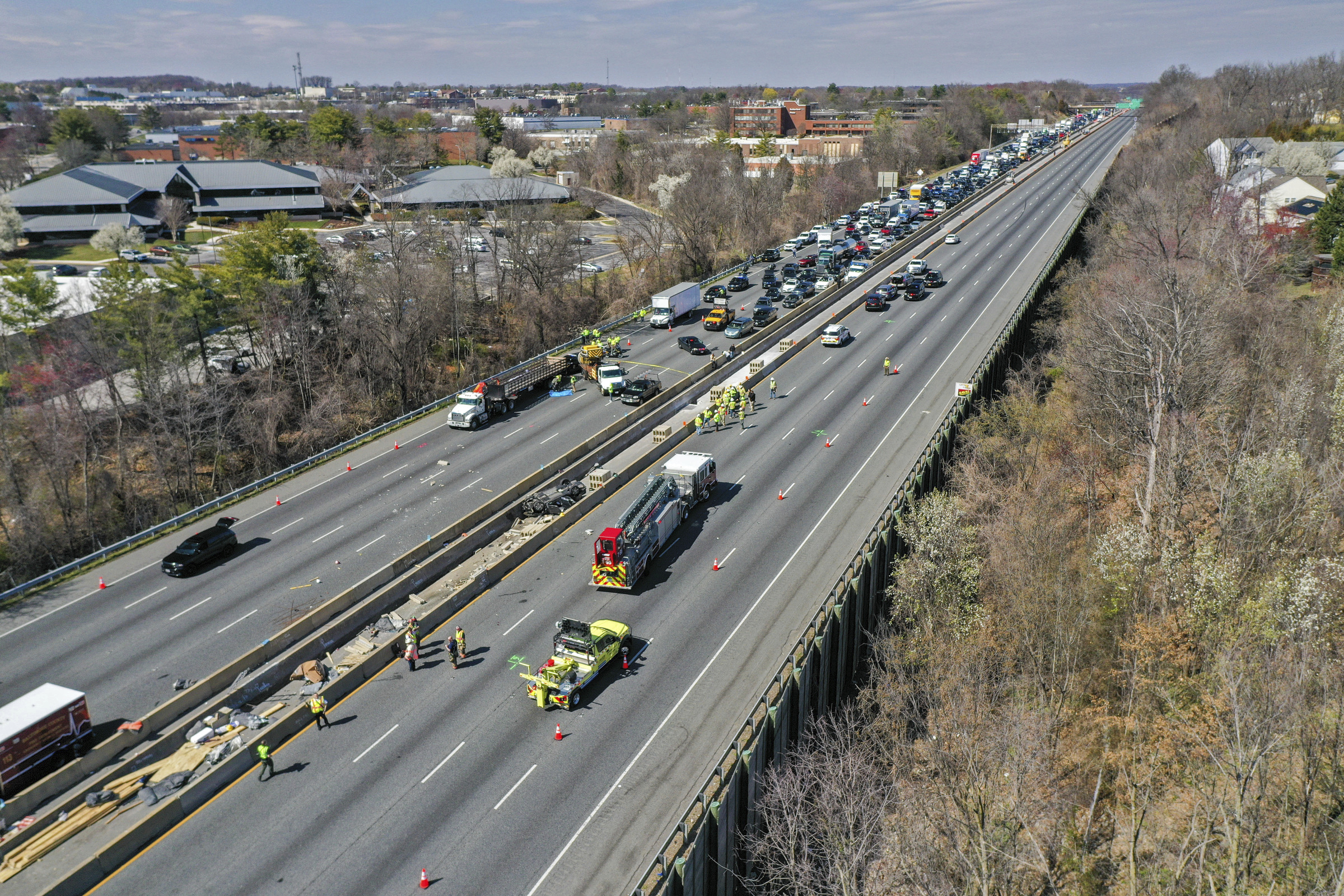 Emergency personnel work at the scene of fatal crash along...