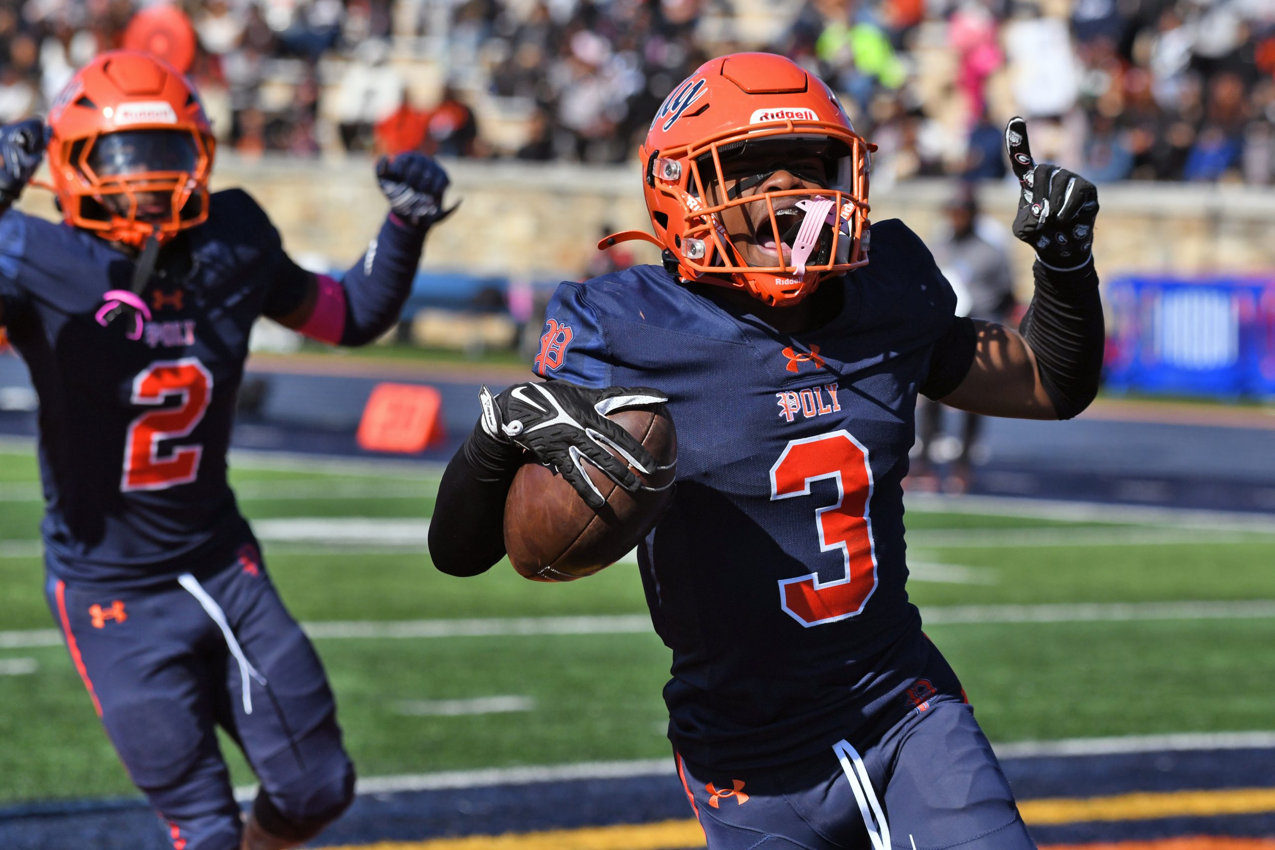 From left, Poly’s Keyon Rice and Maison Johnson celebrate Johnson’s...