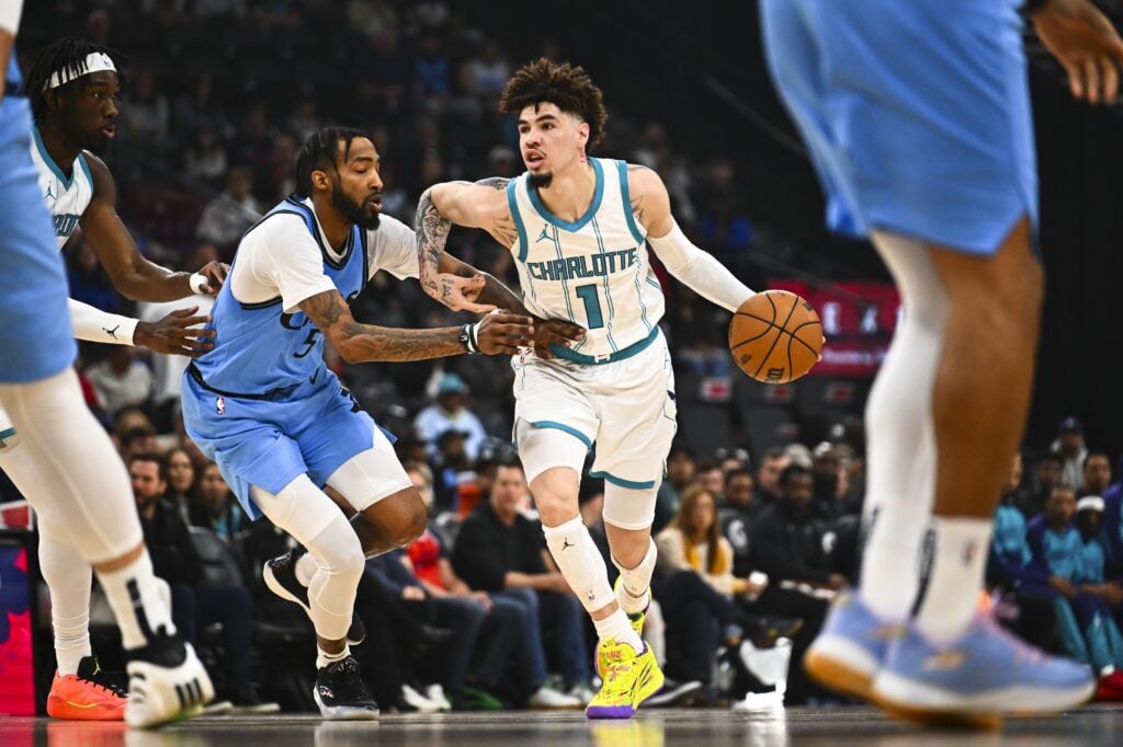 Mar 16, 2025; Inglewood, California, USA; Charlotte Hornets guard LaMelo Ball (1) moves the ball against LA Clippers forward Derrick Jones Jr. (55) during the first half at Intuit Dome. Mandatory Credit: Jonathan Hui-Imagn Images