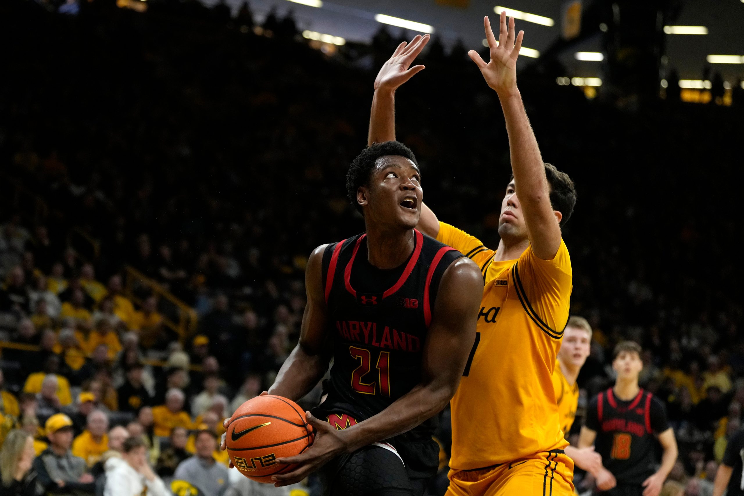 Maryland forward Pharrel Payne drives to the basket past Iowa...