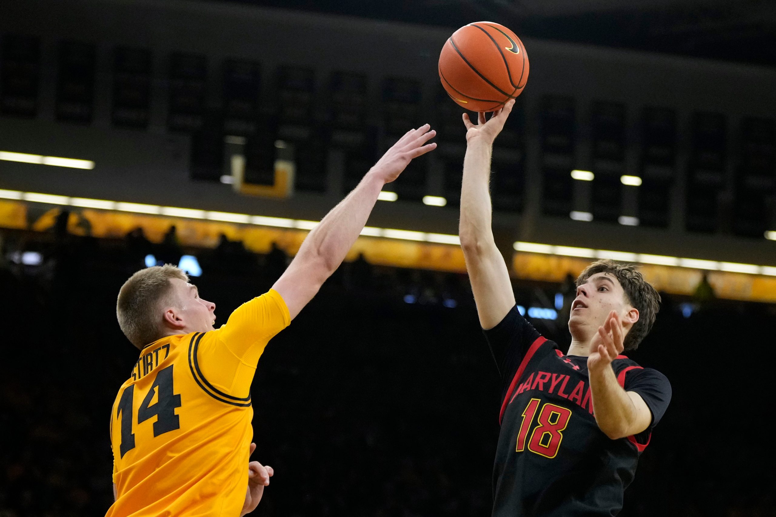 Maryland guard Guillermo del Pino (18) shoots over Iowa guard...