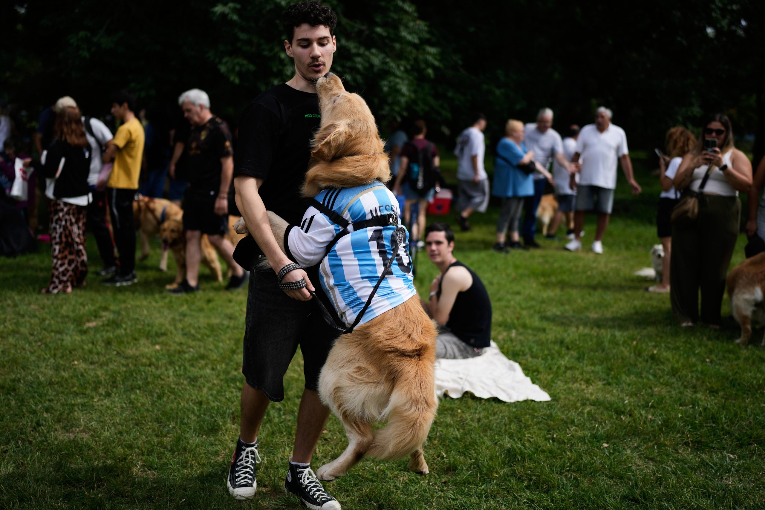 A man plays with his dog at a Palermo neighborhood...