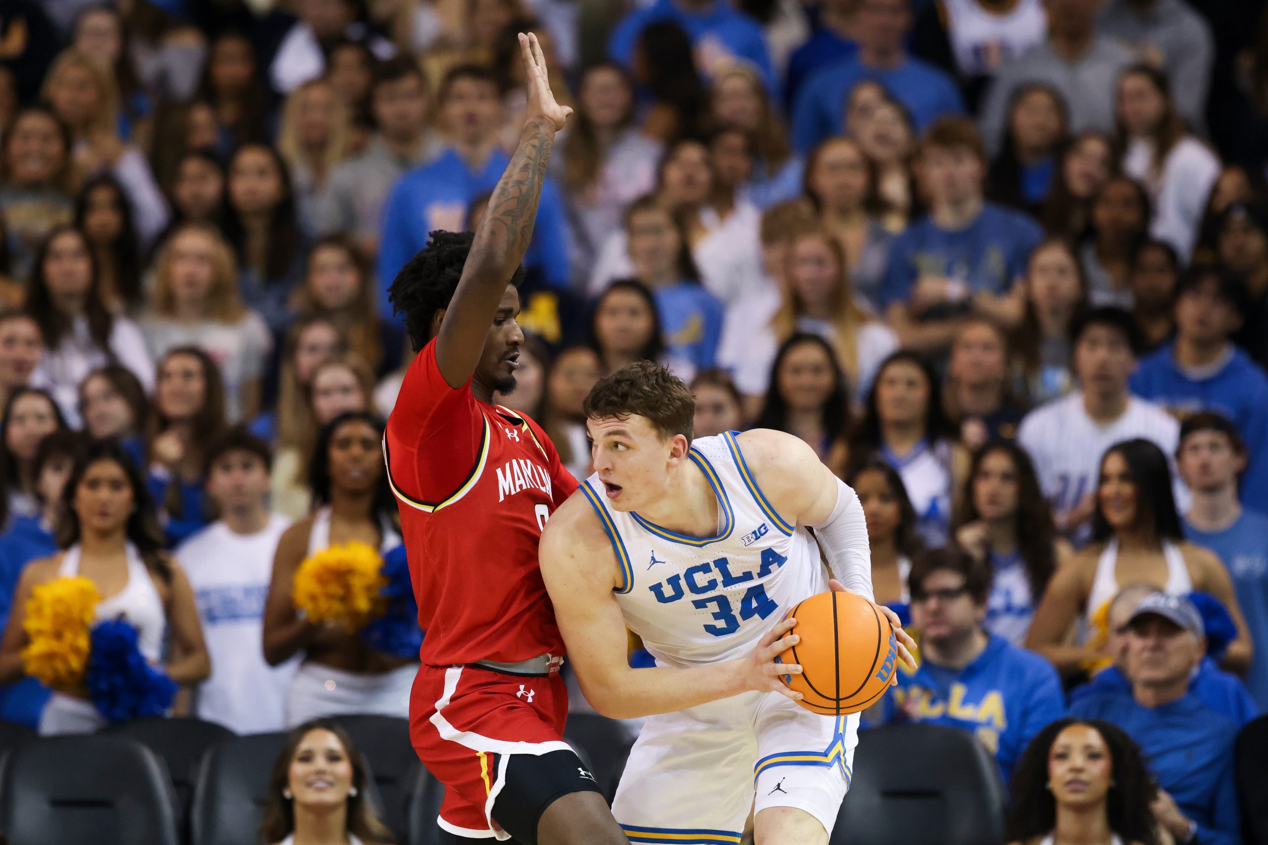 UCLA forward Tyler Bilodeau (34) looks on with the ball...