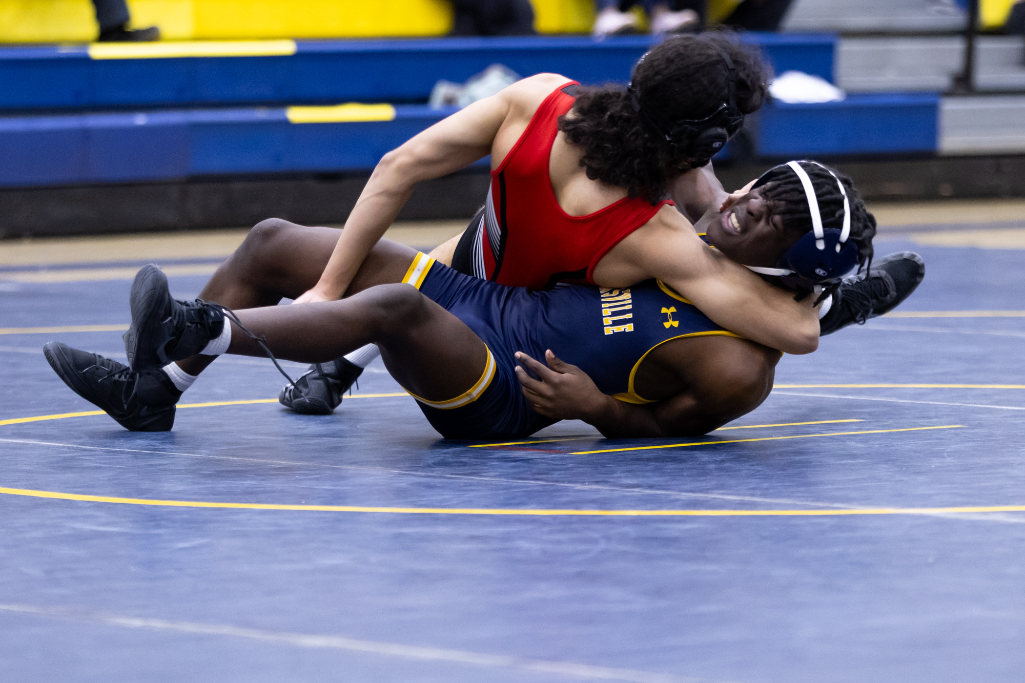 Catonsvilleâs Julian Epps fights off a pin attempt by Kevin...