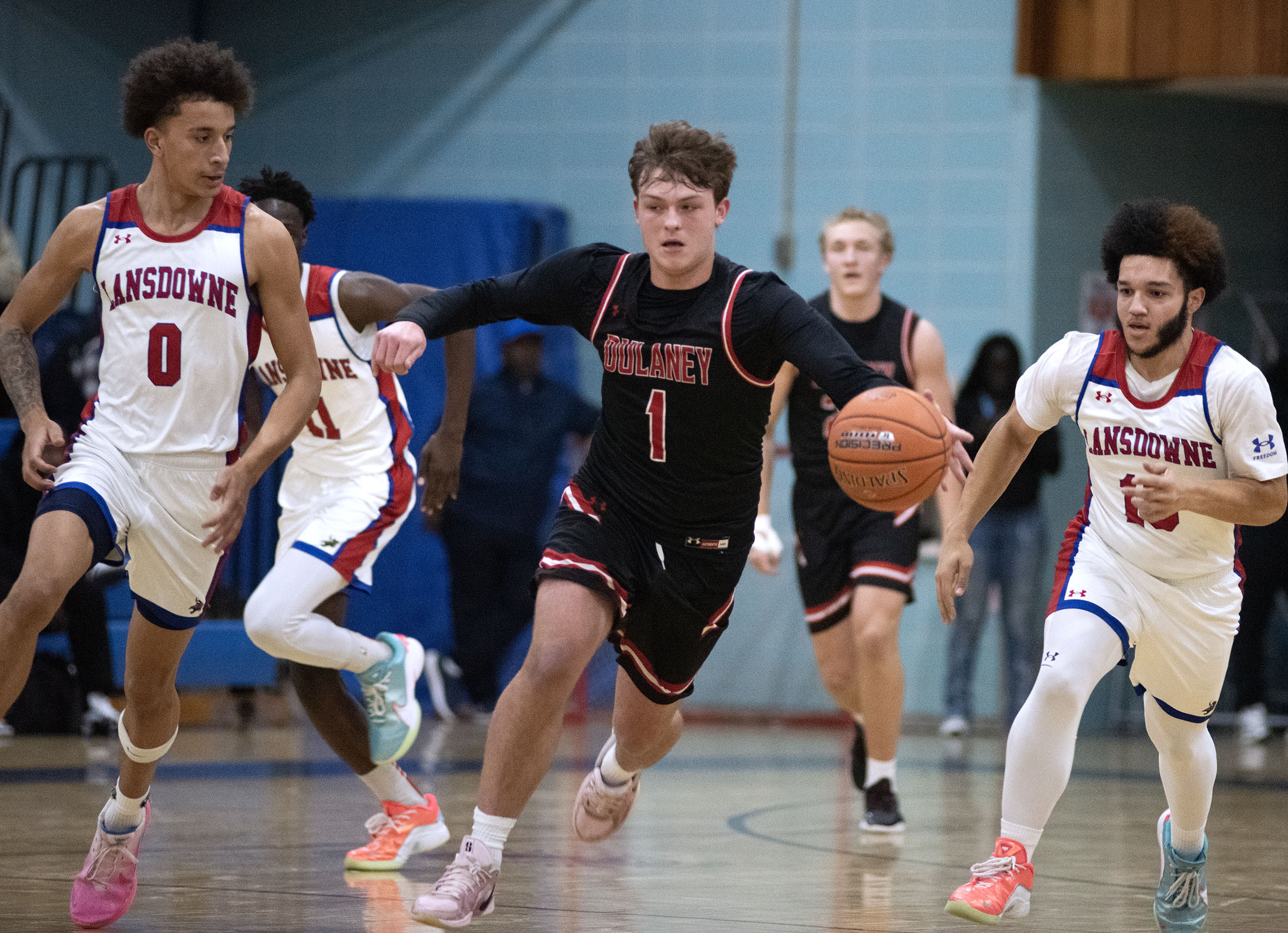 Dulaney's Chase Huber races up court against Lansdowne's Trevor Howard,...