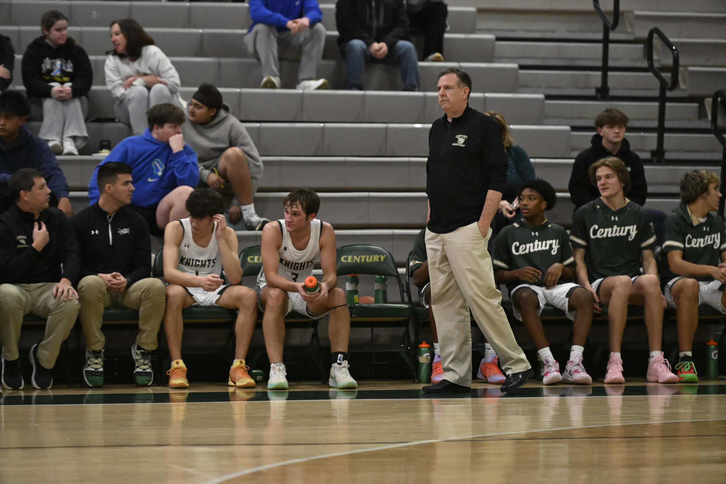 Century coach George Wunder walks the sideline during a basketball...