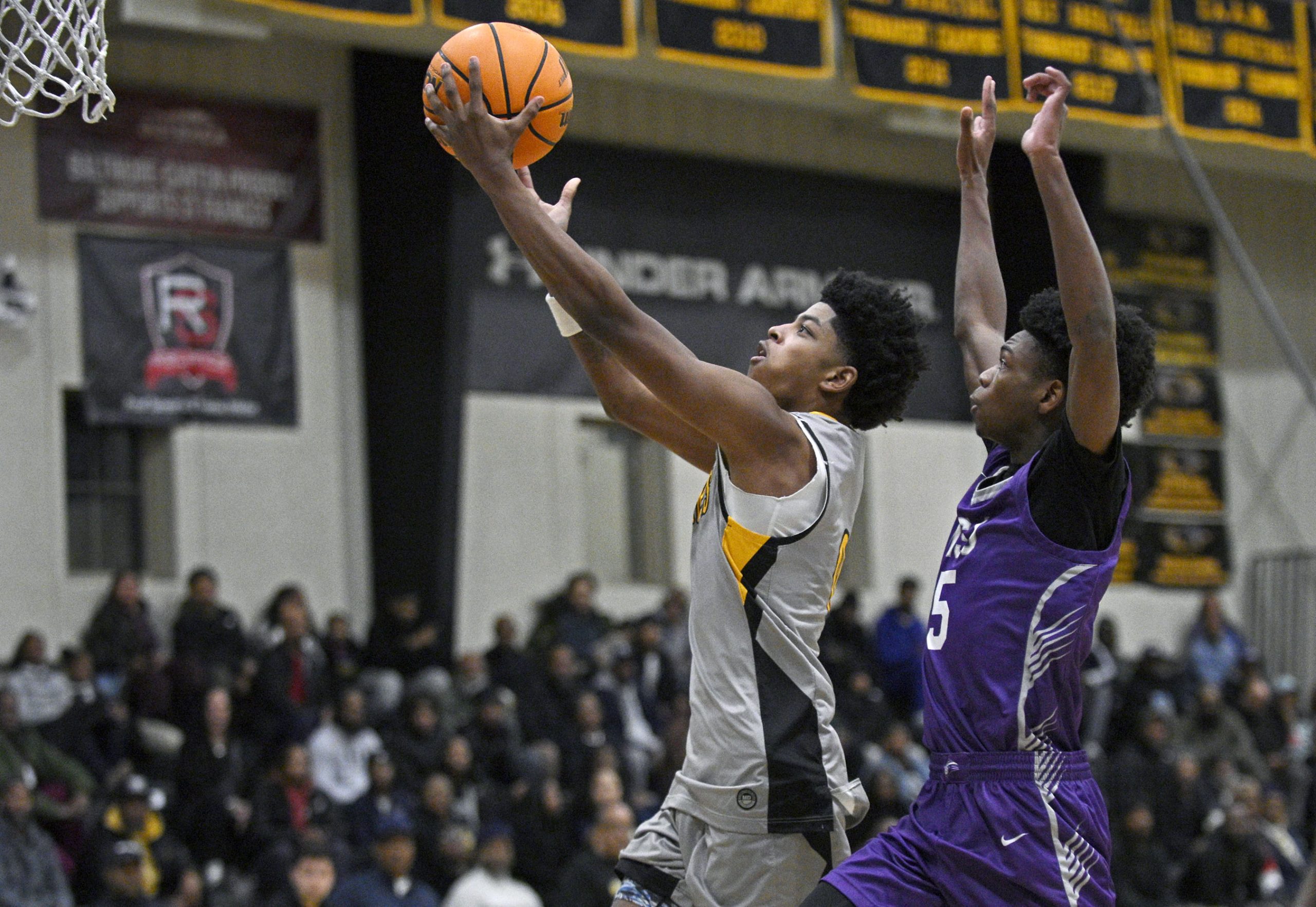 St. Francesâ Terence Jones III, left, drives to the basket...