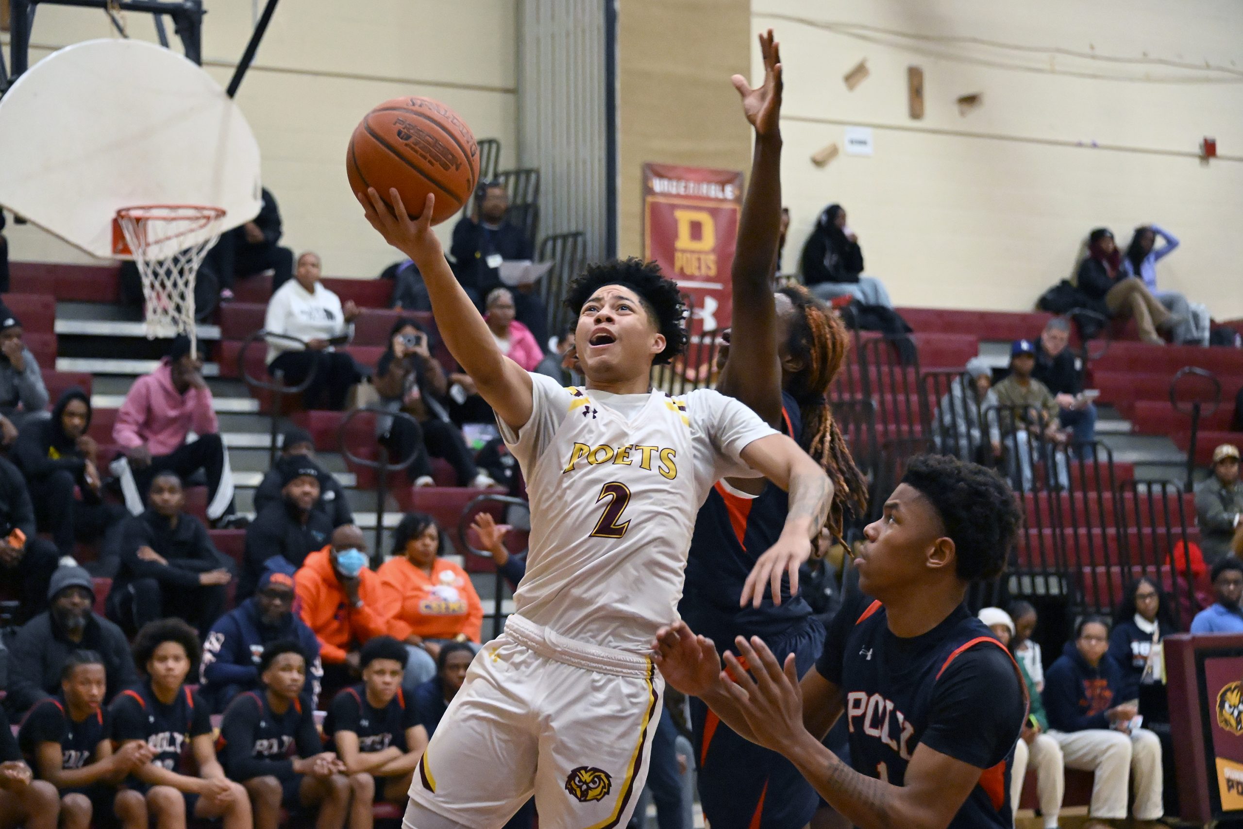 From left, Dunbarâs James Foster scores under pressure from Polyâs...