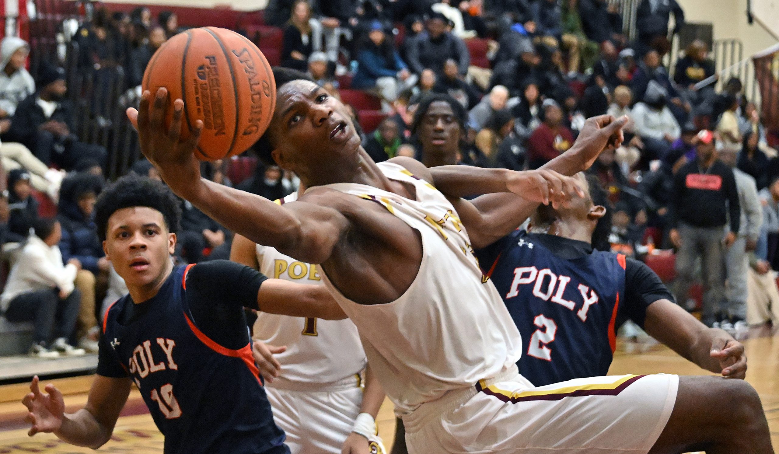 From left, Polyâs Judah Johnson watches as Dunbarâs Jordan Battle...