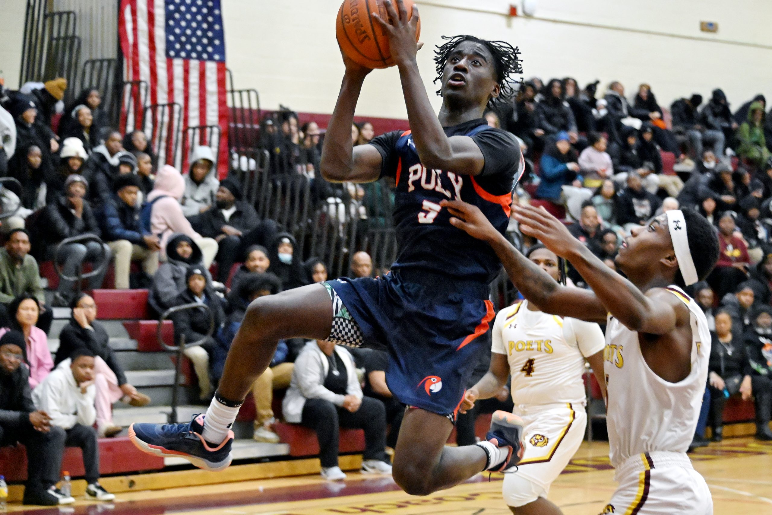 Polyâs Victor Gray leaps beyond the defense of Dunbarâs Greggory...