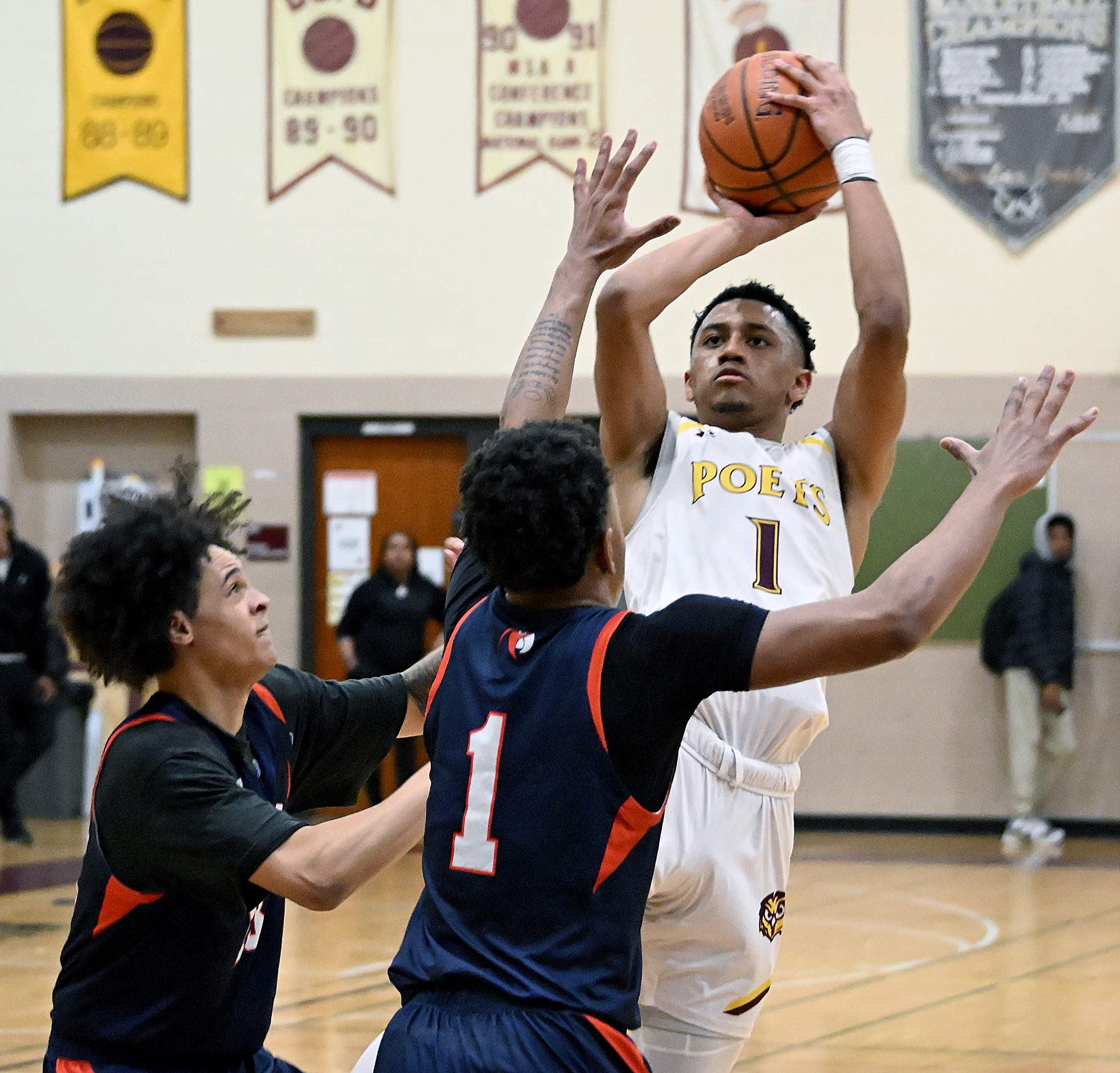From left, Polyâs Nicholas Williams and Chance Jordan defend Dunbarâs...
