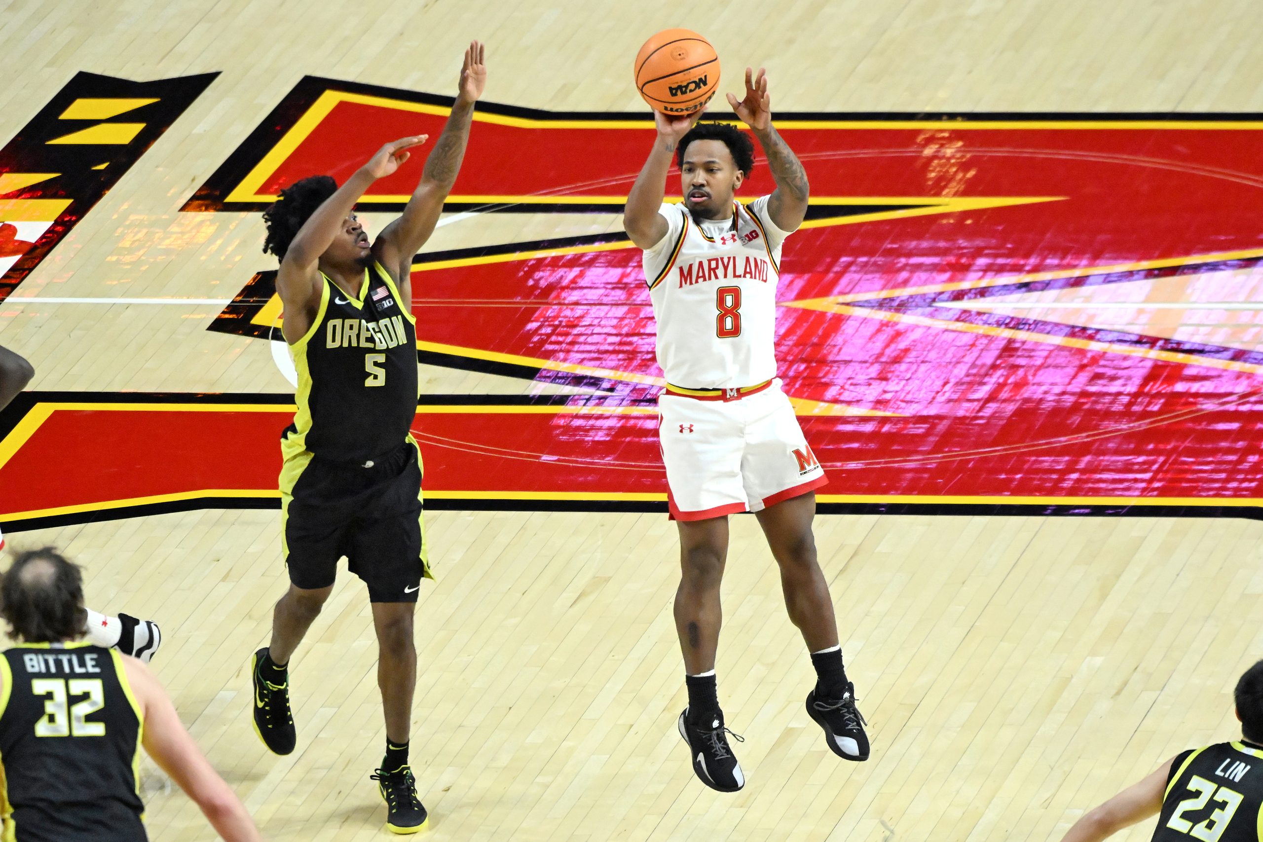 Oregonâs Takai Simpkins defends Marylandâs David Coit as he scores...