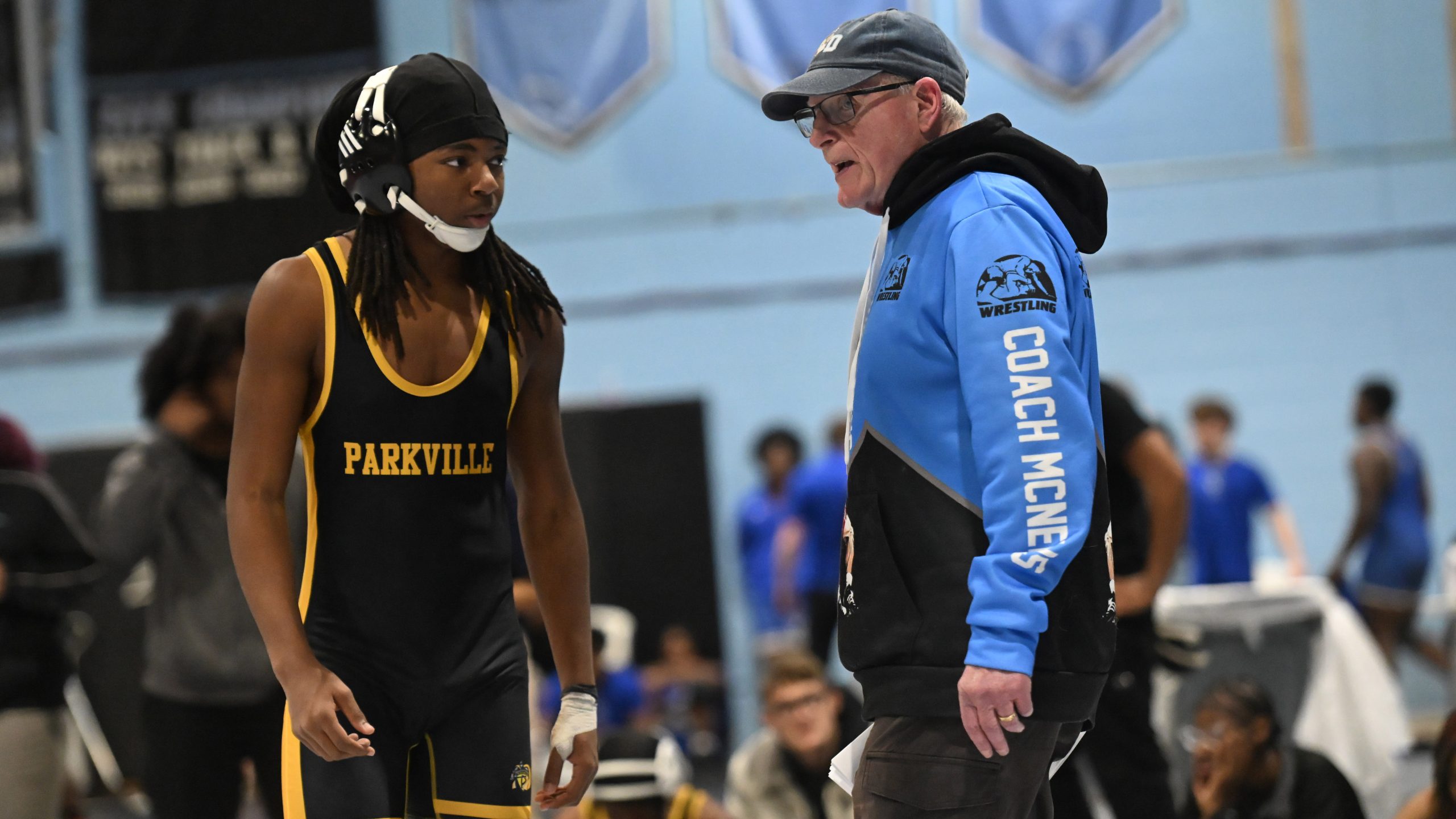 Parkville wrestling head coach Desi McNelis give instruction to wrestler...