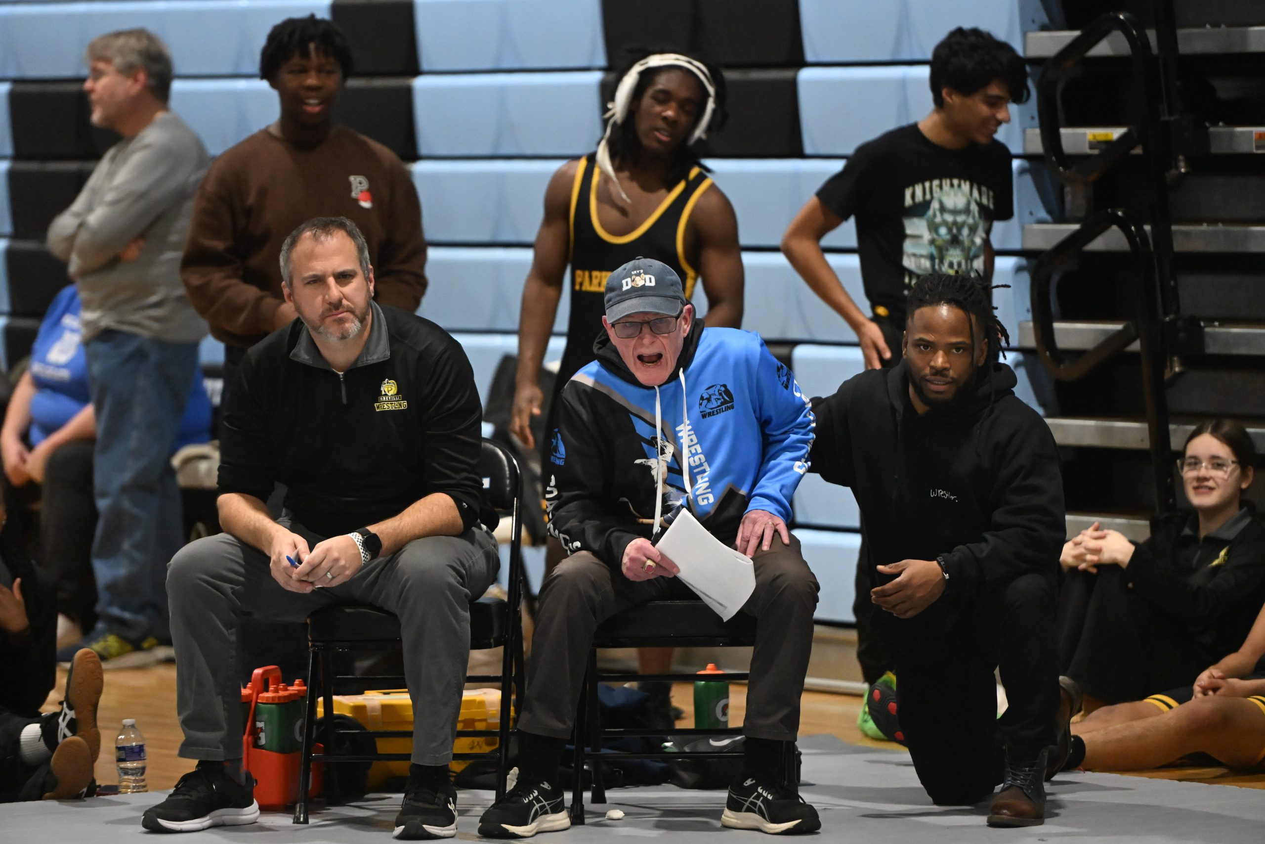 Parkville wrestling head coach Desi McNelis, center, is joined by...