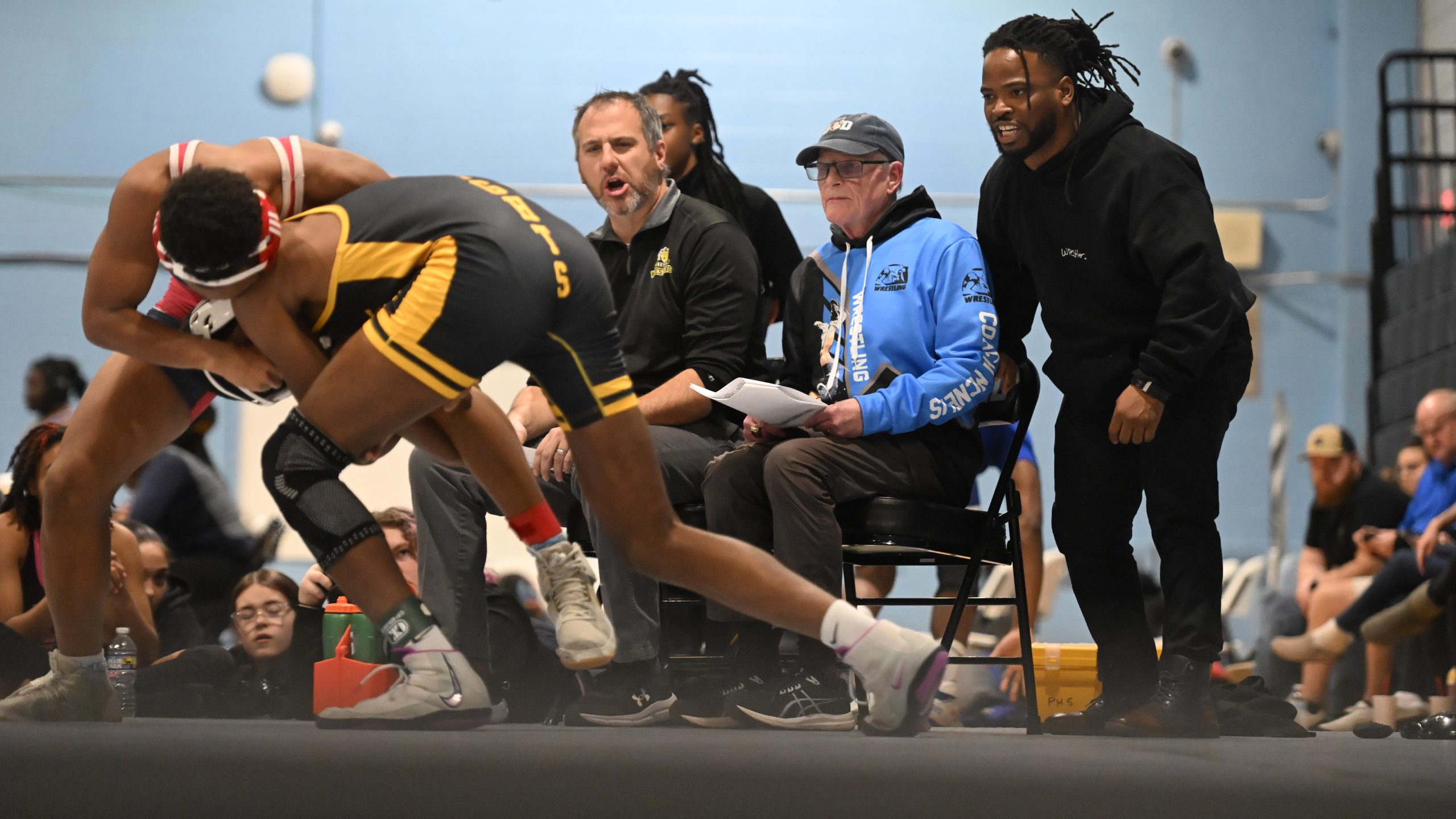 Parkville wrestling head coach Desi McNelis, center, is joined by...