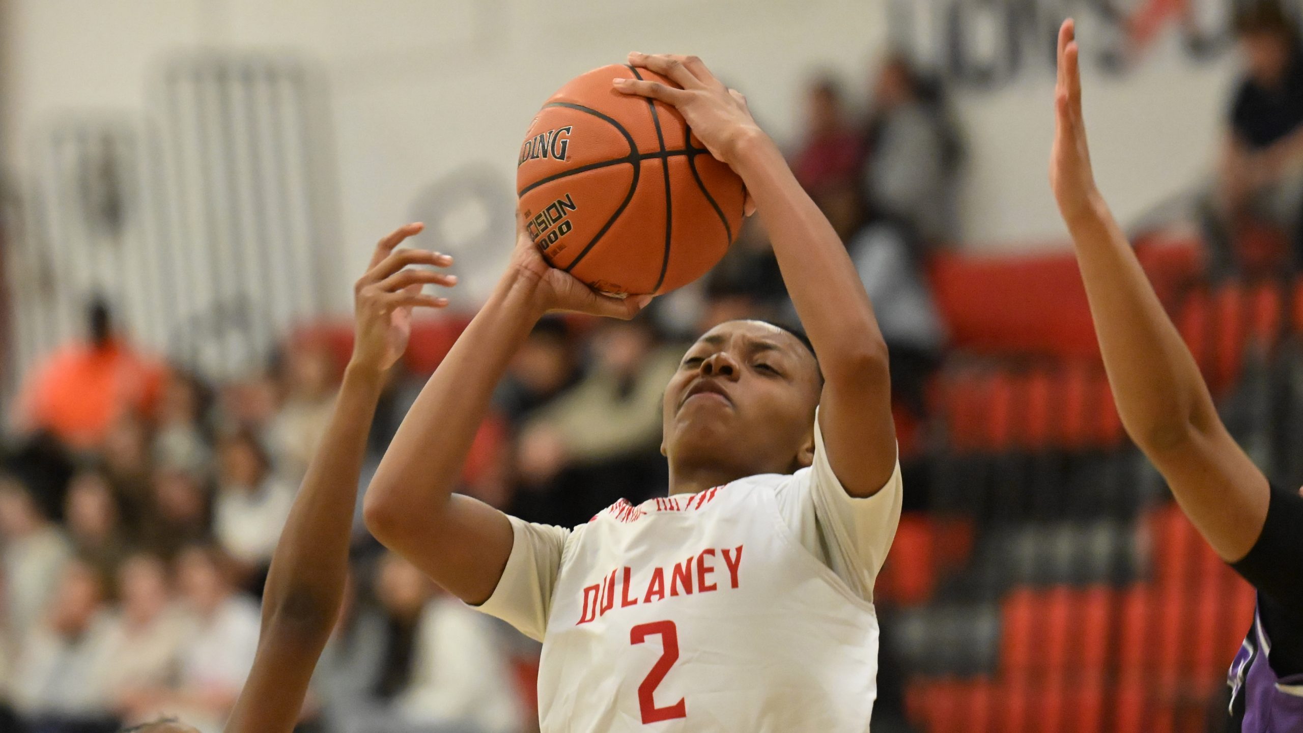 Dulaney's Morgan Young struggles to get a clean shot off,...