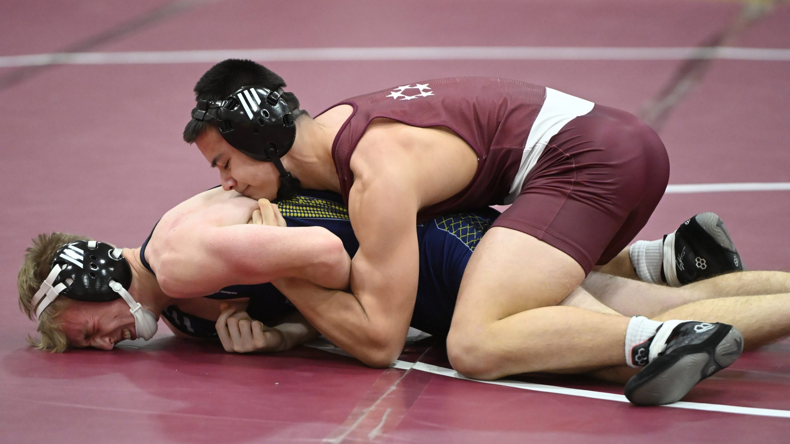 Towson's Nick Toung controls Perry Hall's Clay Reynolds in the...