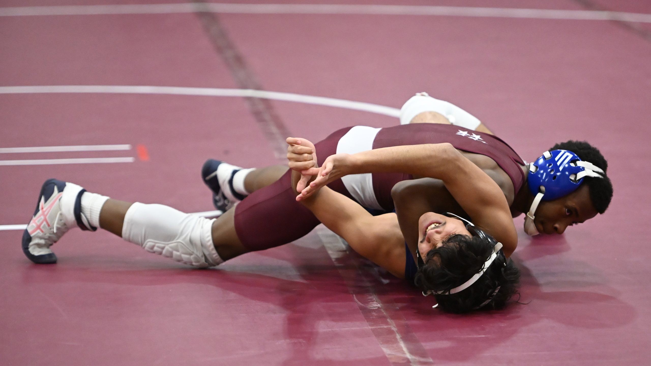 Towson's Braylon Lawson tries to pin Perry Hall's Prasiddha Thapaliya...