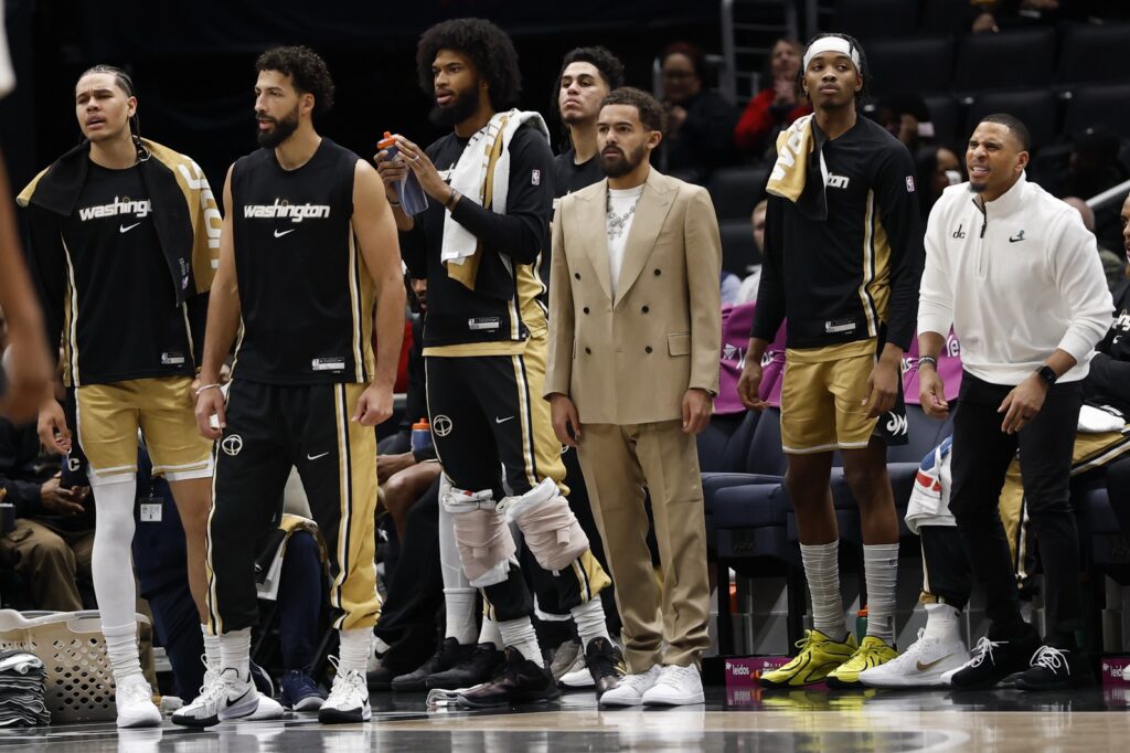  Newly acquired Washington Wizards guard Trae Young (M) looks on from the bench with teammates against the New Orleans Pelicans in the first half at Capital One Arena.