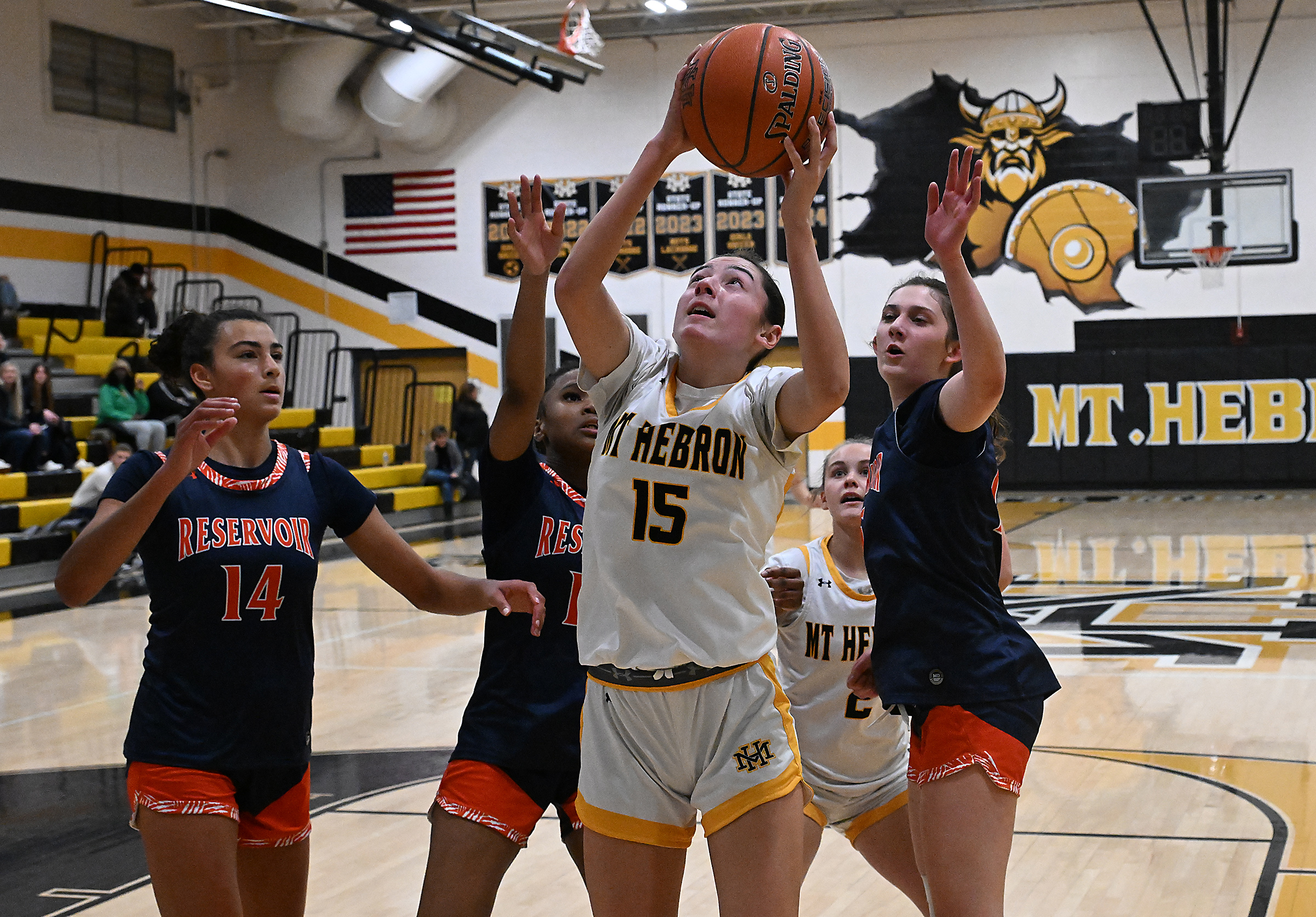 Hebron #15, Sophie Mitchell pulls down an offensive rebound in...