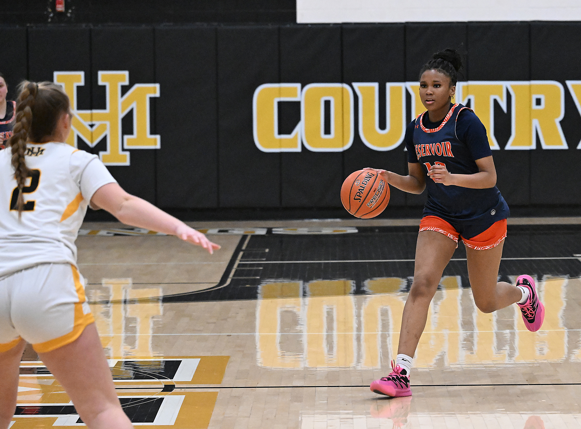 Reservoir #12, Sydney Shelton, brings the ball upcourt in the...