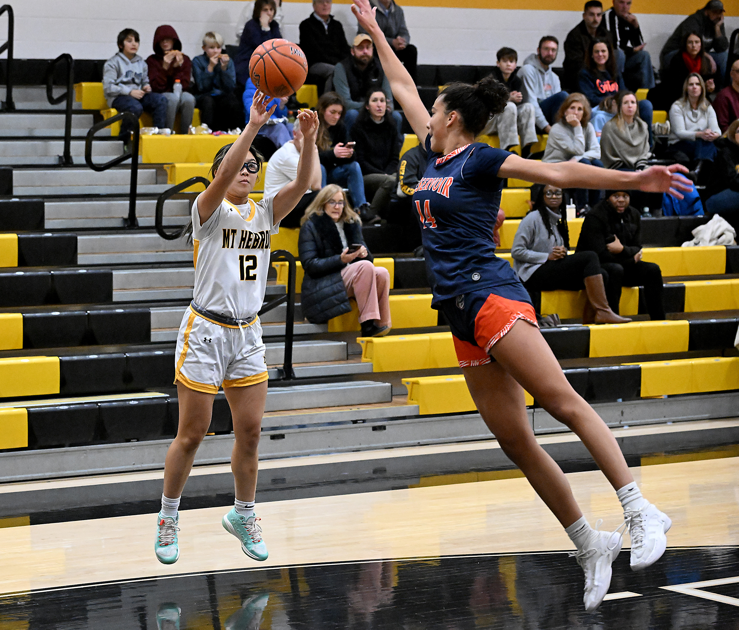 Hebron #12, Pearl Prasartkarnka, attempts a long two under pressure...