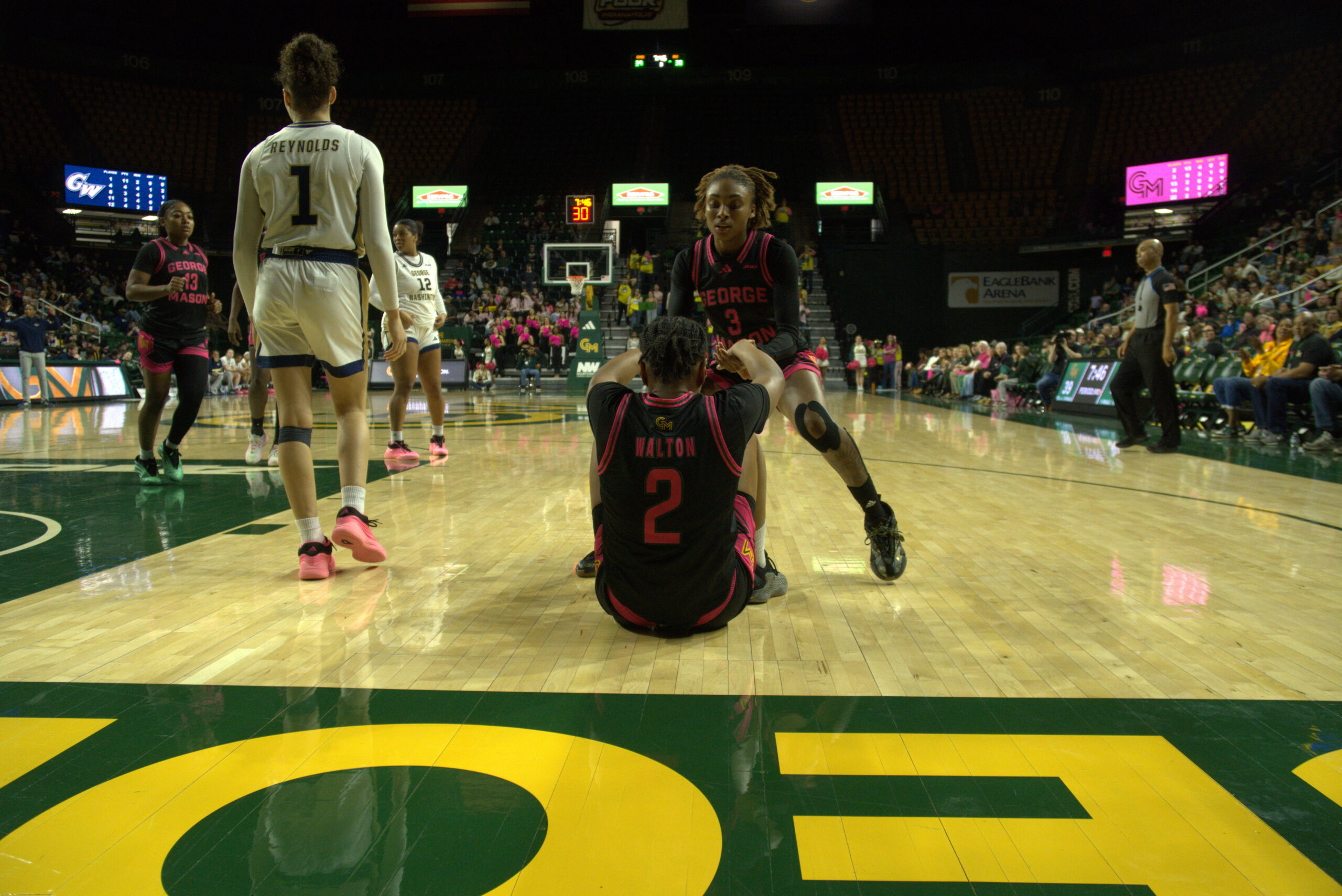 Zahirah Walton is helped to her feet by Kennedy Harris.