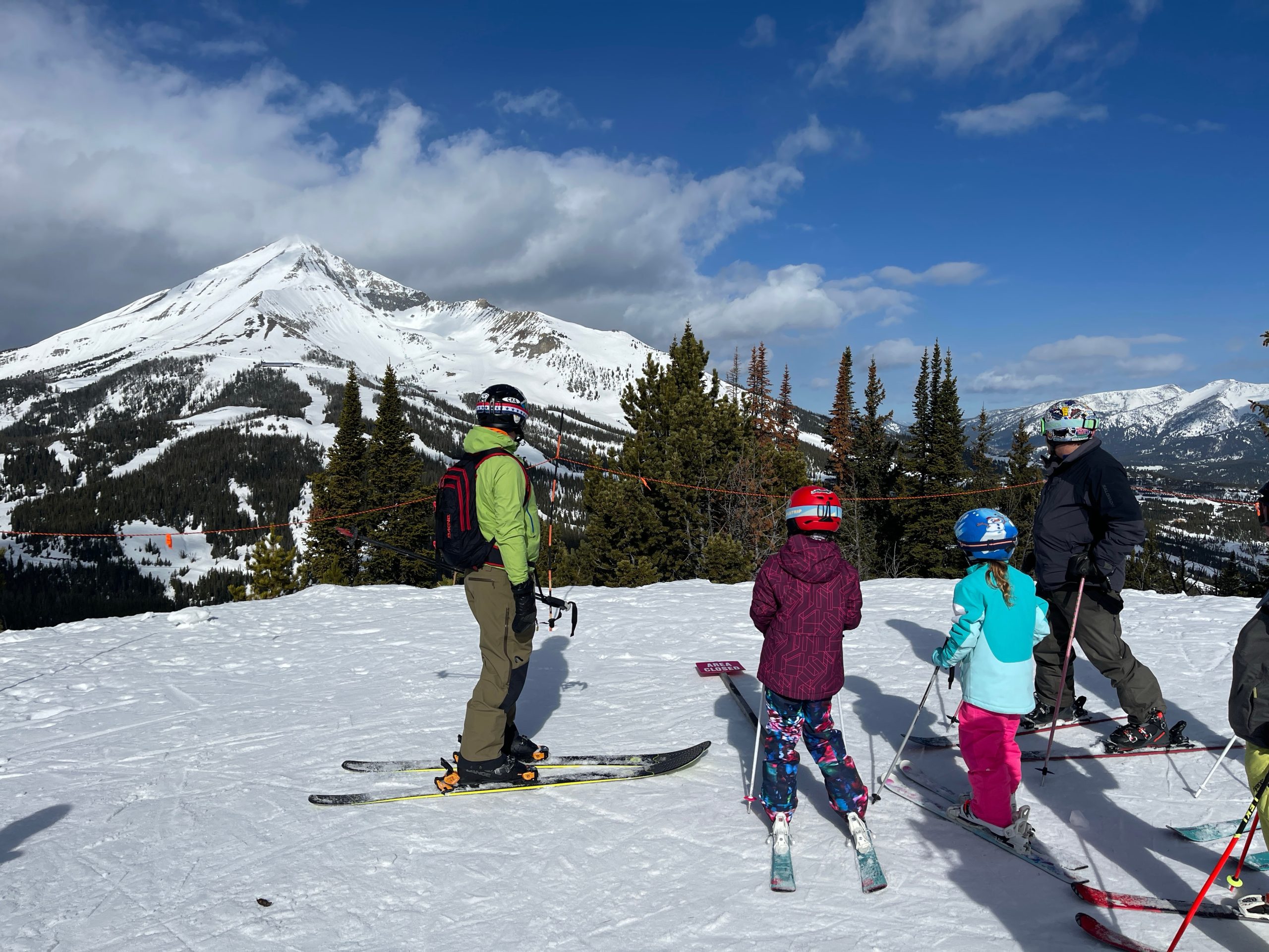 Skiers pause atop Big Skyâs Andesite Mountain to take in...